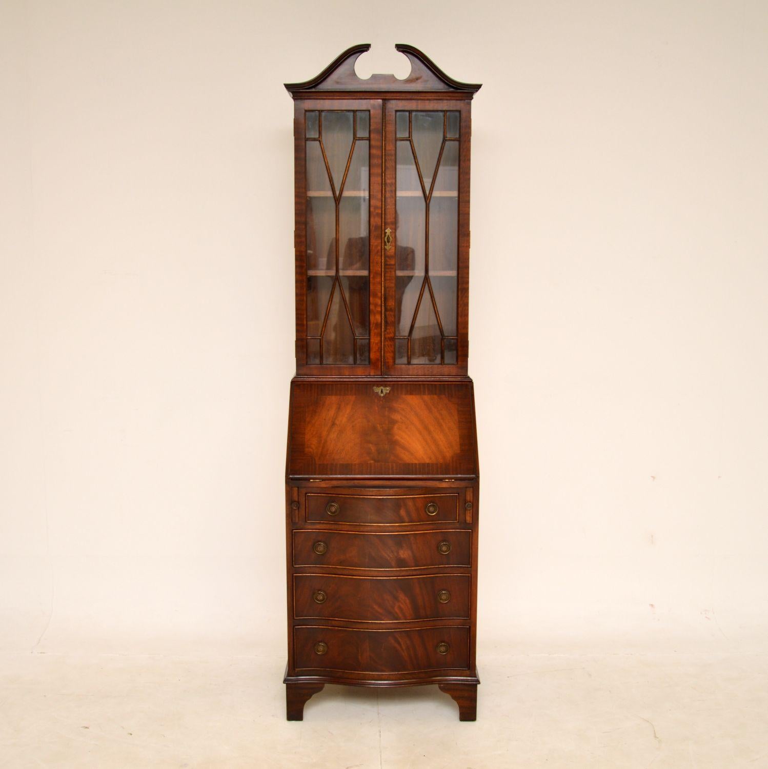 A smart and very well made antique bureau bookcase of very slim proportions. This is in the Georgian style, it was made in England and dates from around the 1950s.

It is of excellent quality, and is a most useful item. The drawer fronts are