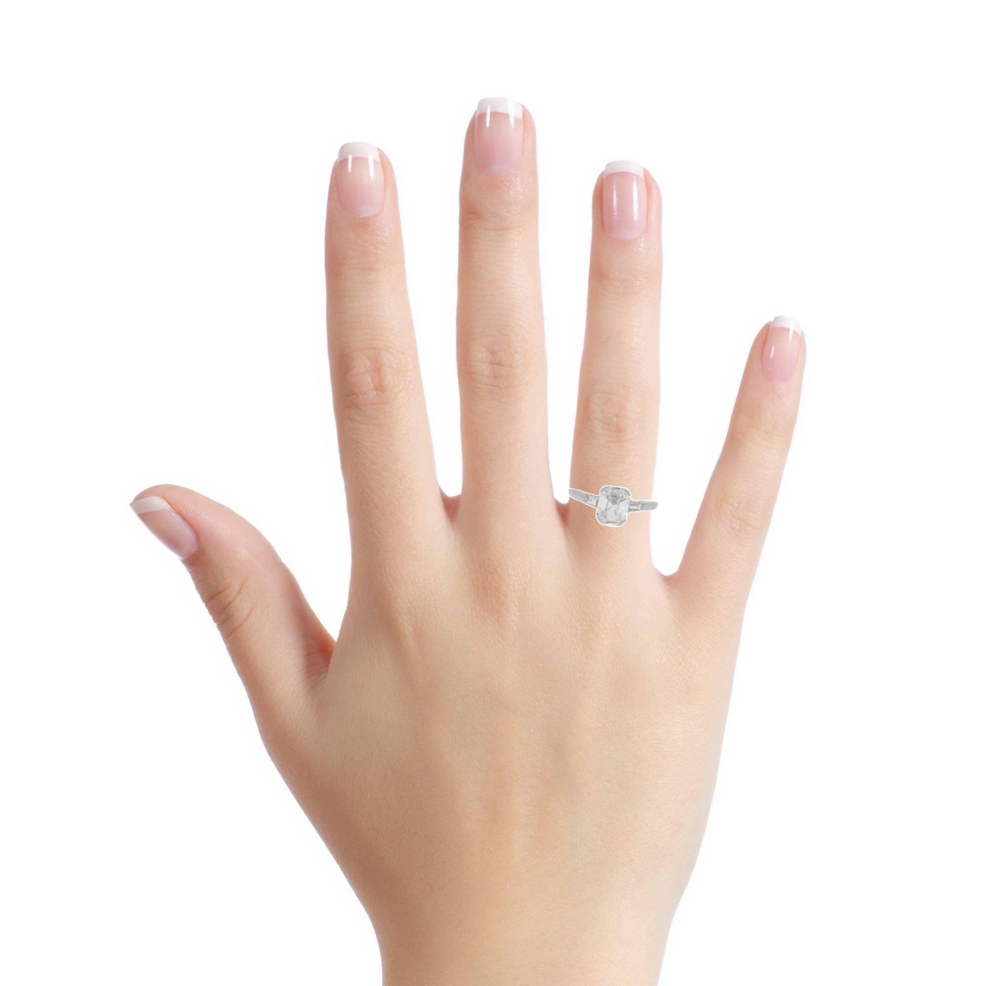 A timeless flat antique step cut diamond ring, ca. 1900, in platinum, featuring a unique central diamond, flanked by two diamond baguettes. 
The centre diamond weighs 1.01 carats and is of G colour and VS2 clarity, accompanied by a GIA certificate.