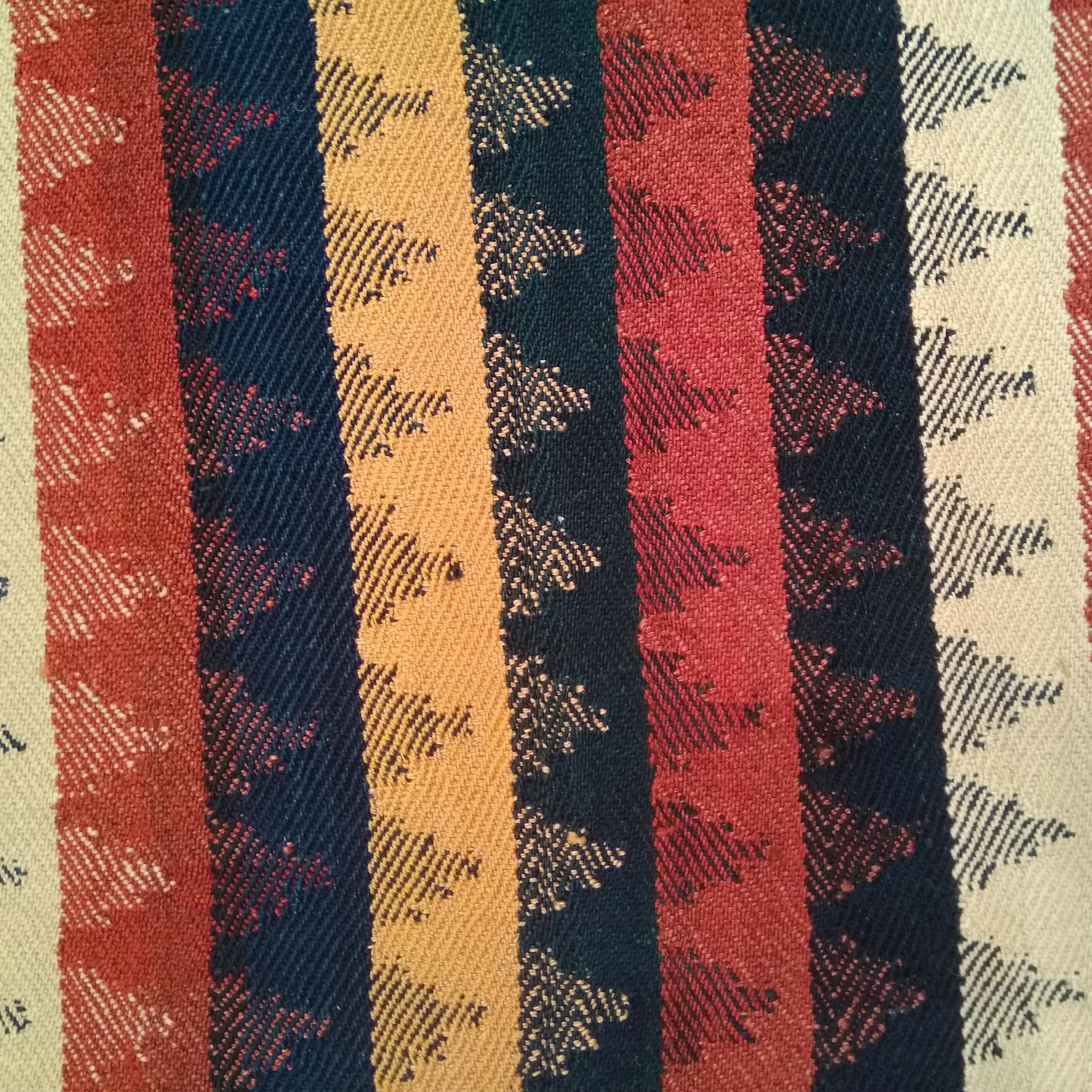 A finely woven wool flat-weave from the Azeri tribe in Armenia, located in the southern Caucasus, distinguished by a tartan-like composition of polychrome vertical bands with a zig-zag contour. This type of effect is achieved through a complex plain