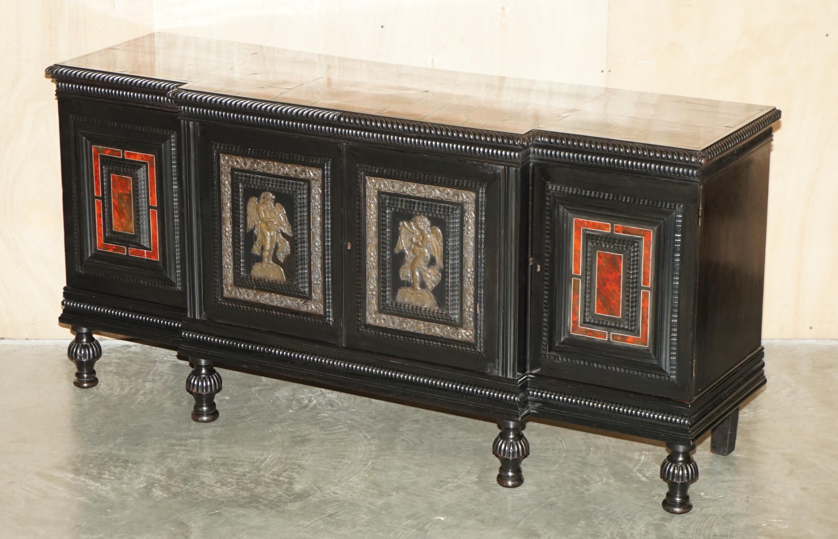 Royal House Antiques

Royal House Antiques is delighted to offer for sale this absolutely exquisite 18th Century Flemish breakfront sideboard with Bronze Cherub Repoussé panels and Tortoiseshell inlay 

Please note the delivery fee listed is just a