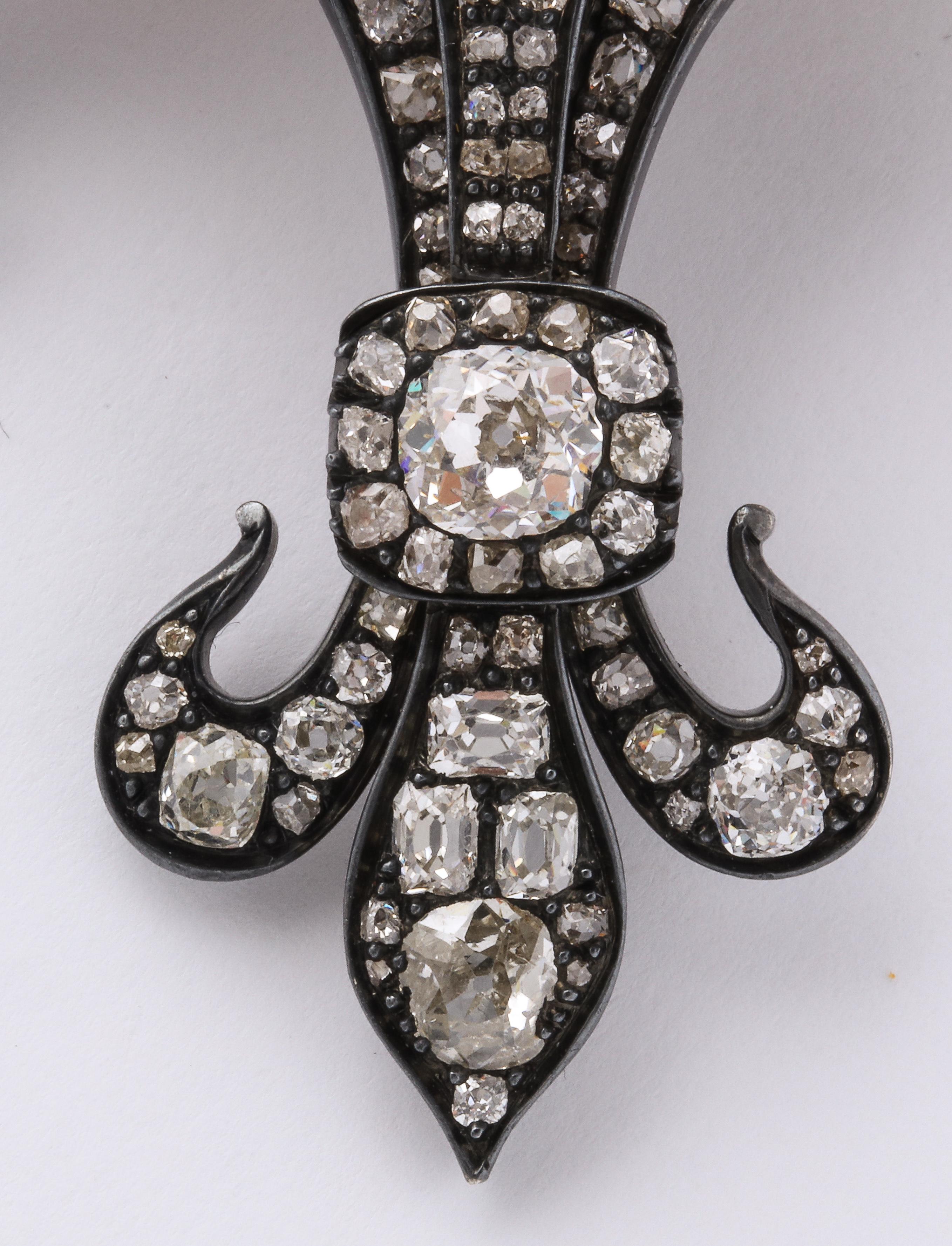 Antique Fleur de Lis Diamond Gold pendant brooch in 14k gold set with over 124 diamonds.

Material:
14k gold, 31 gm

Stones: 
Over 124 diamonds, 213 carat old mine cut h/vvs

Measurements:
3 1/4 inch by 2 inch wide, 3/16 inch deep
