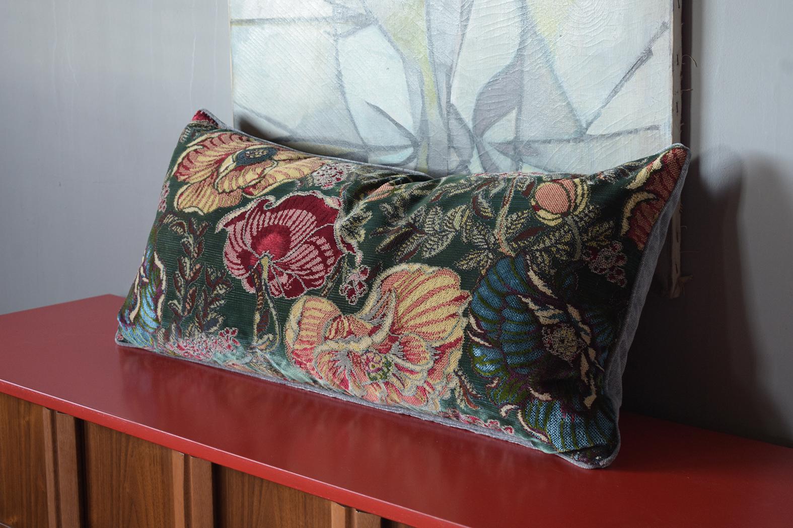 Experience the allure of the 1910s with our vintage botanical velvet pillows. Each pillow vividly displays a rich tapestry of colorful flowers, intertwined with intricate stems and leaves. The solid blue velvet backing perfectly complements the