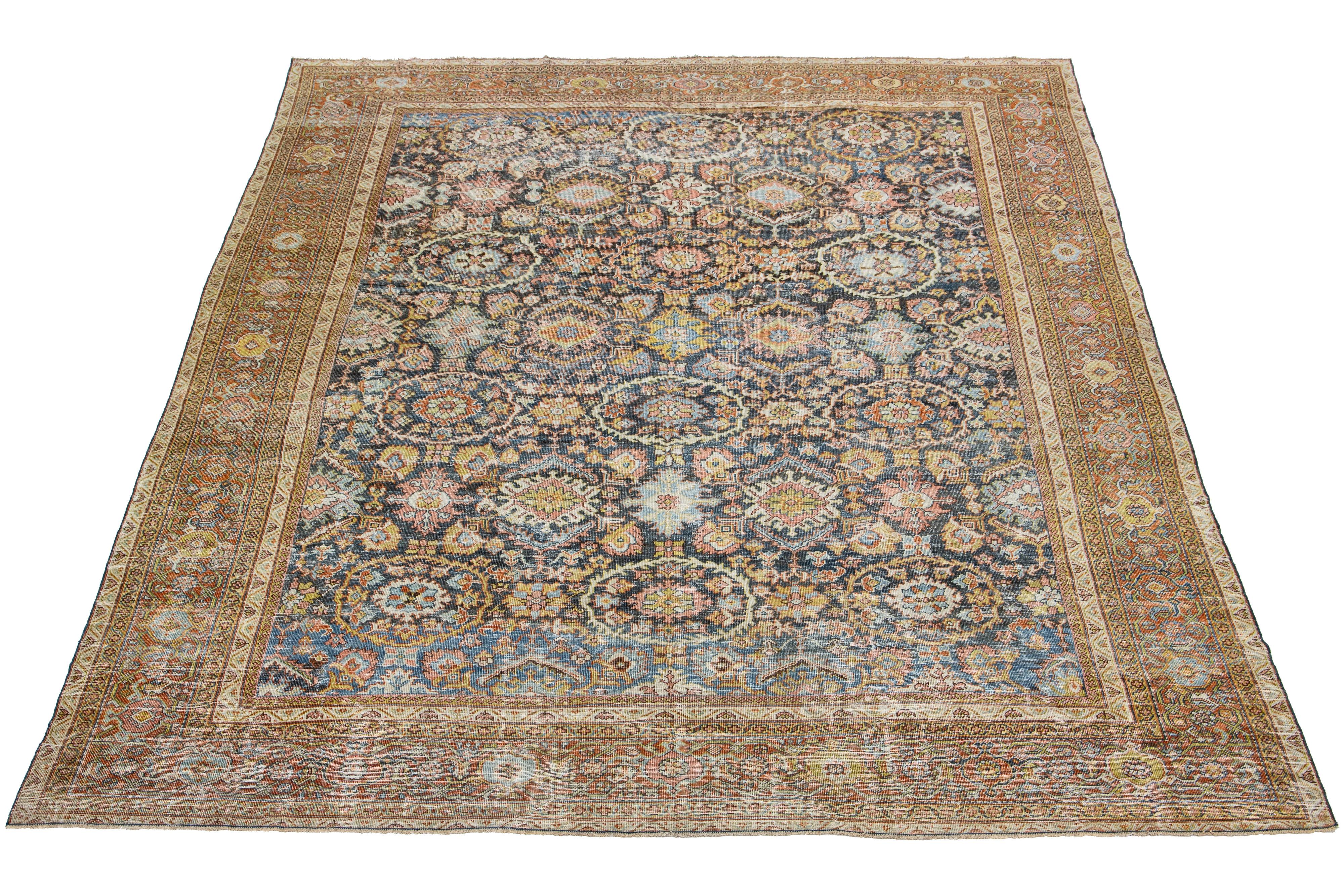 This stunning hand-knotted wool rug boasts a blue field with terracotta, beige, and yellow accents in a captivating all-over floral design.

This rug measures 10'5