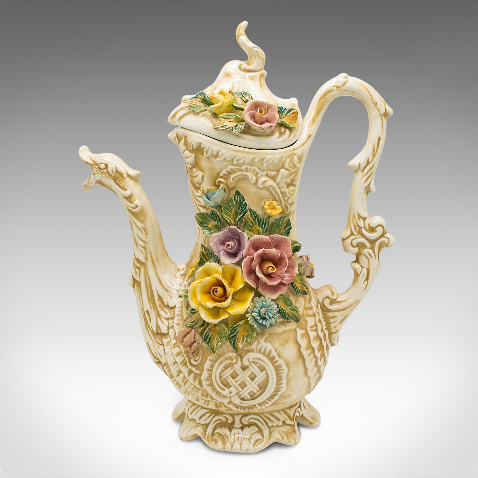This is an antique floral encrusted ewer. An Italian, ceramic decorative pouring jug, dating to the early 20th century, circa 1920.

Striking Italian ewer with prominent foliate decorations
Displays a desirable aged patina and good original