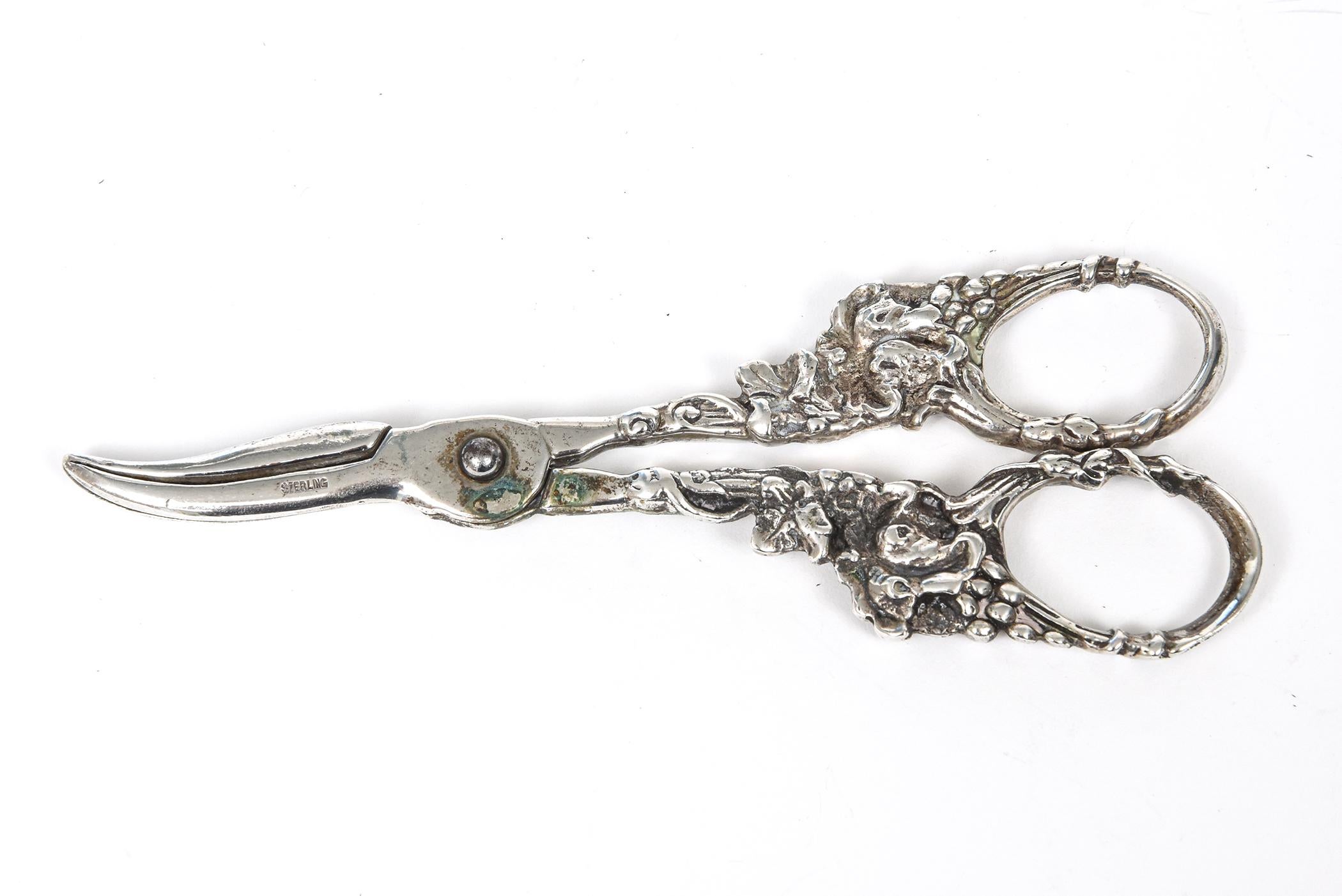 Antique solid sterling silver grape shears featuring a grape and vine floral design. Marked sterling on the blade area. These would be a beautiful addition to any table when you are cutting grapes.