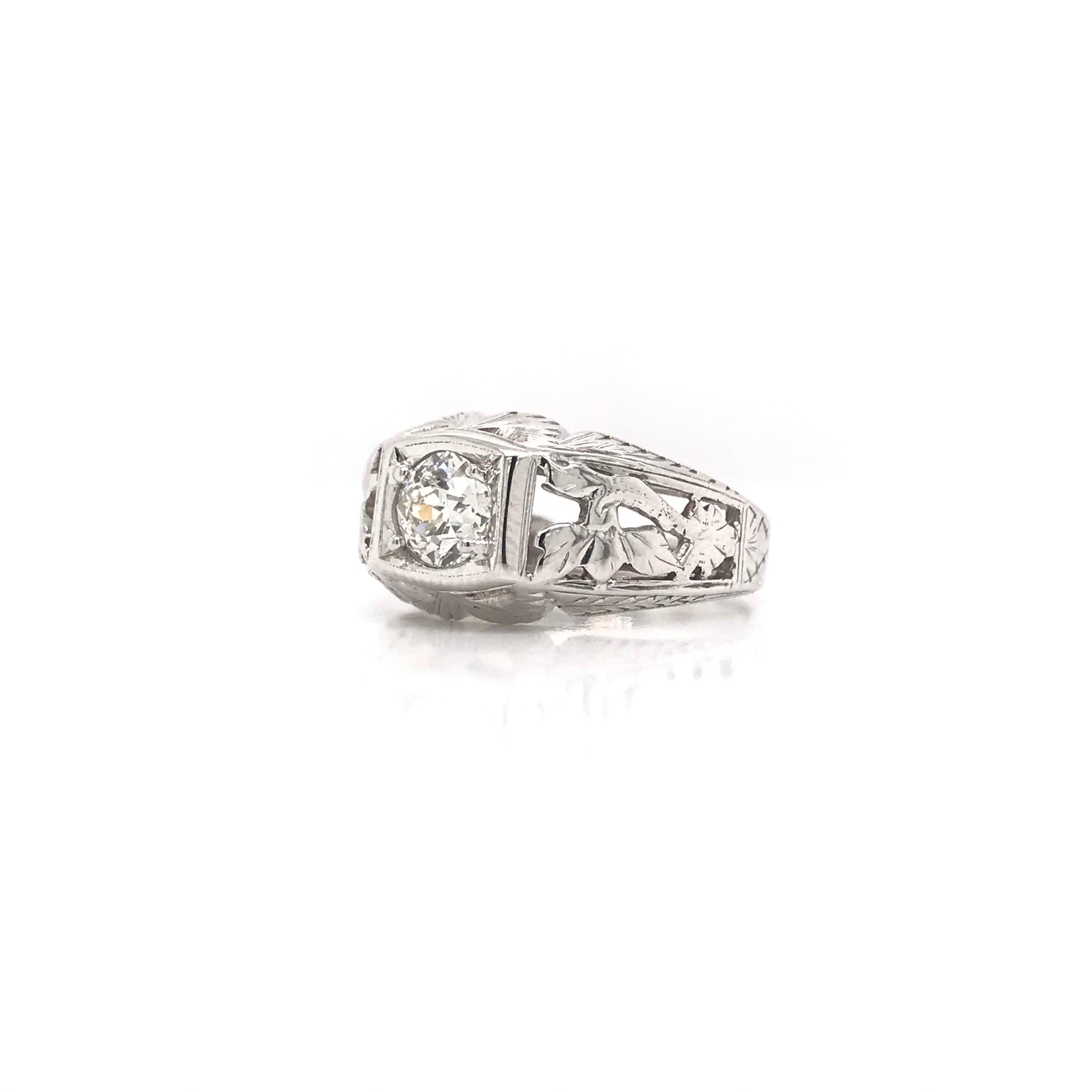 This unique antique piece was handcrafted sometime during the Art Deco design period ( 1920-1940 ). The filigree setting is 18k white gold and features a 0.61 carat old mine cut diamond. The diamond grades J color & approximately SI2 in clarity. The