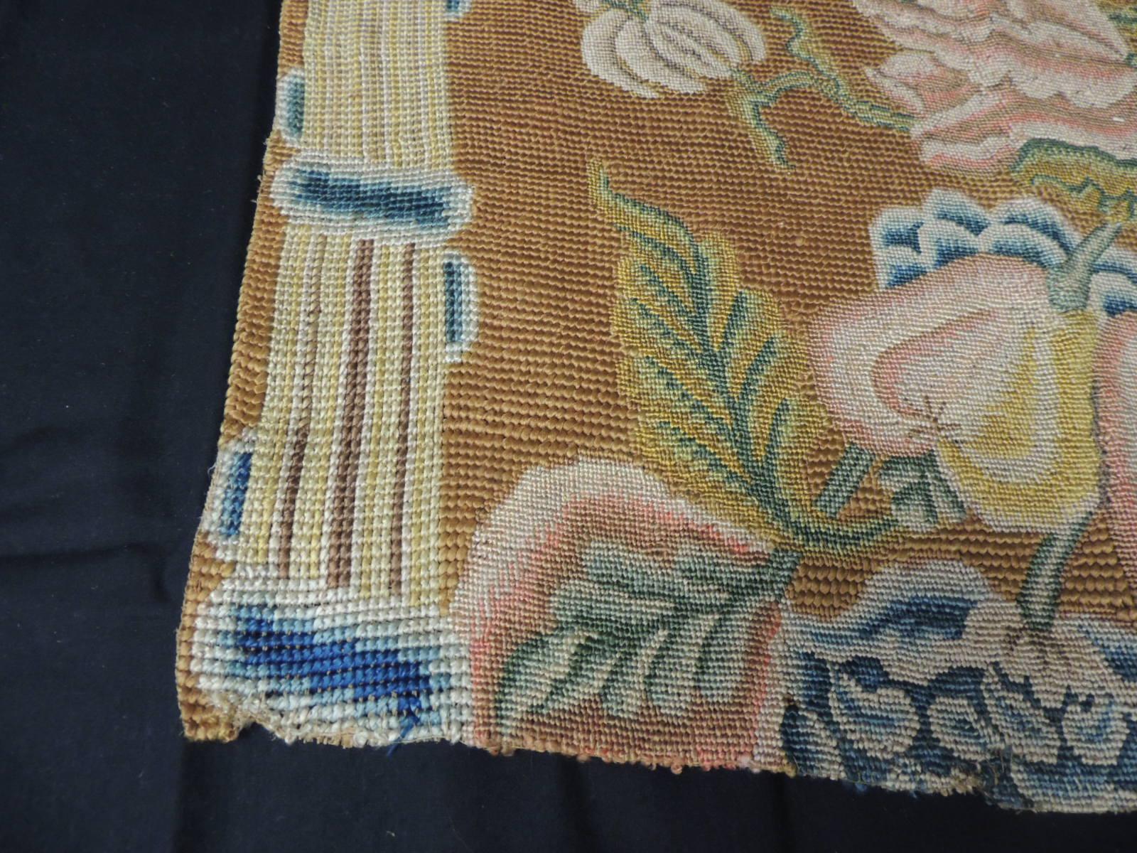 Antique Floral Needlework Tapestry Fragment, depicting flowers and trellis.
In shades of tan, blue, gold, pink green and yellow.
Sold as is.
Size:  16.5