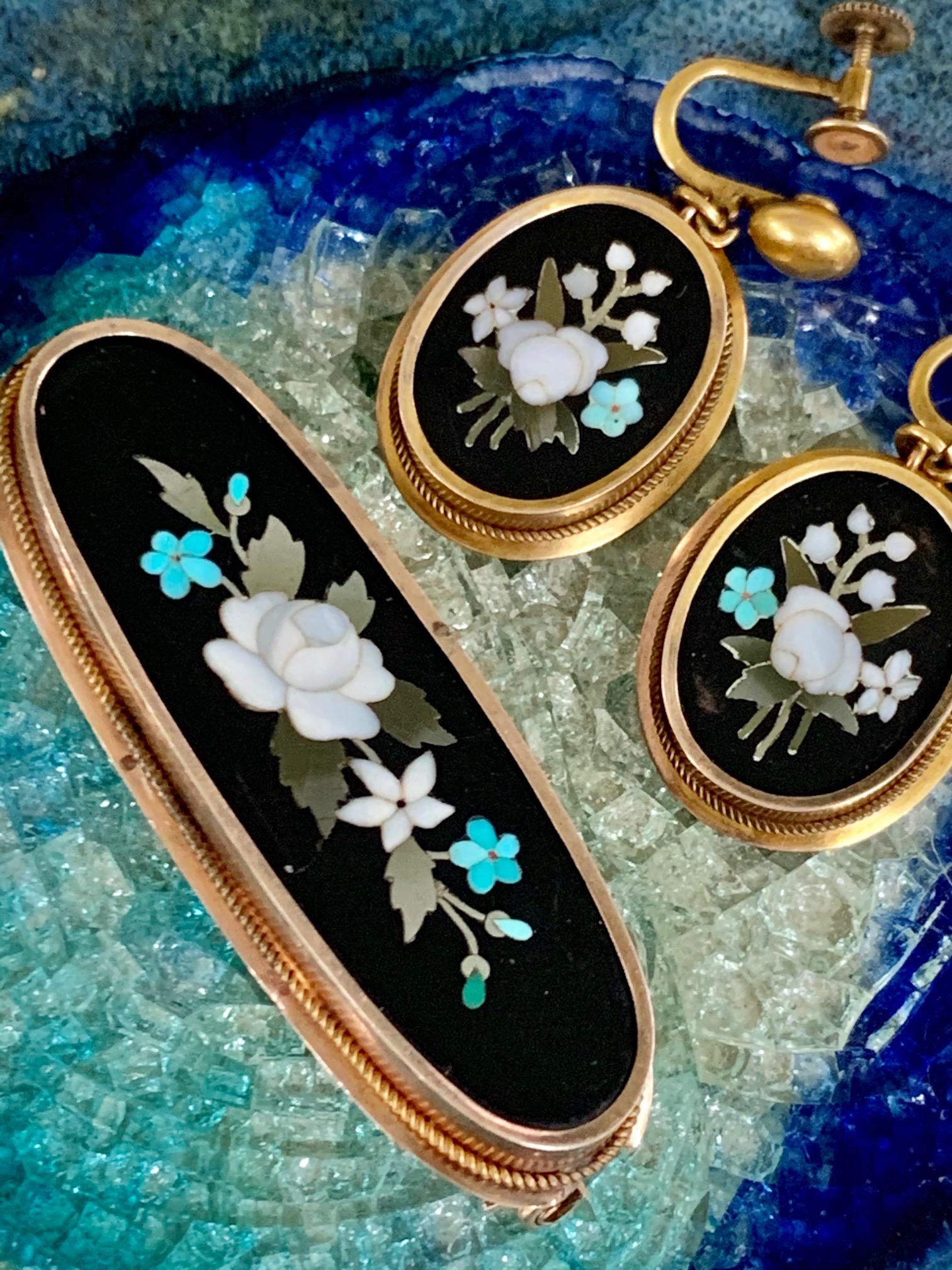 Pietra Dura pieces are absolutely lovely and this set is no different.  This matching brooch and screw back earring set feature floral scenes in white, green, blue on a black background.  

The earrings could easily be converted from screw back to