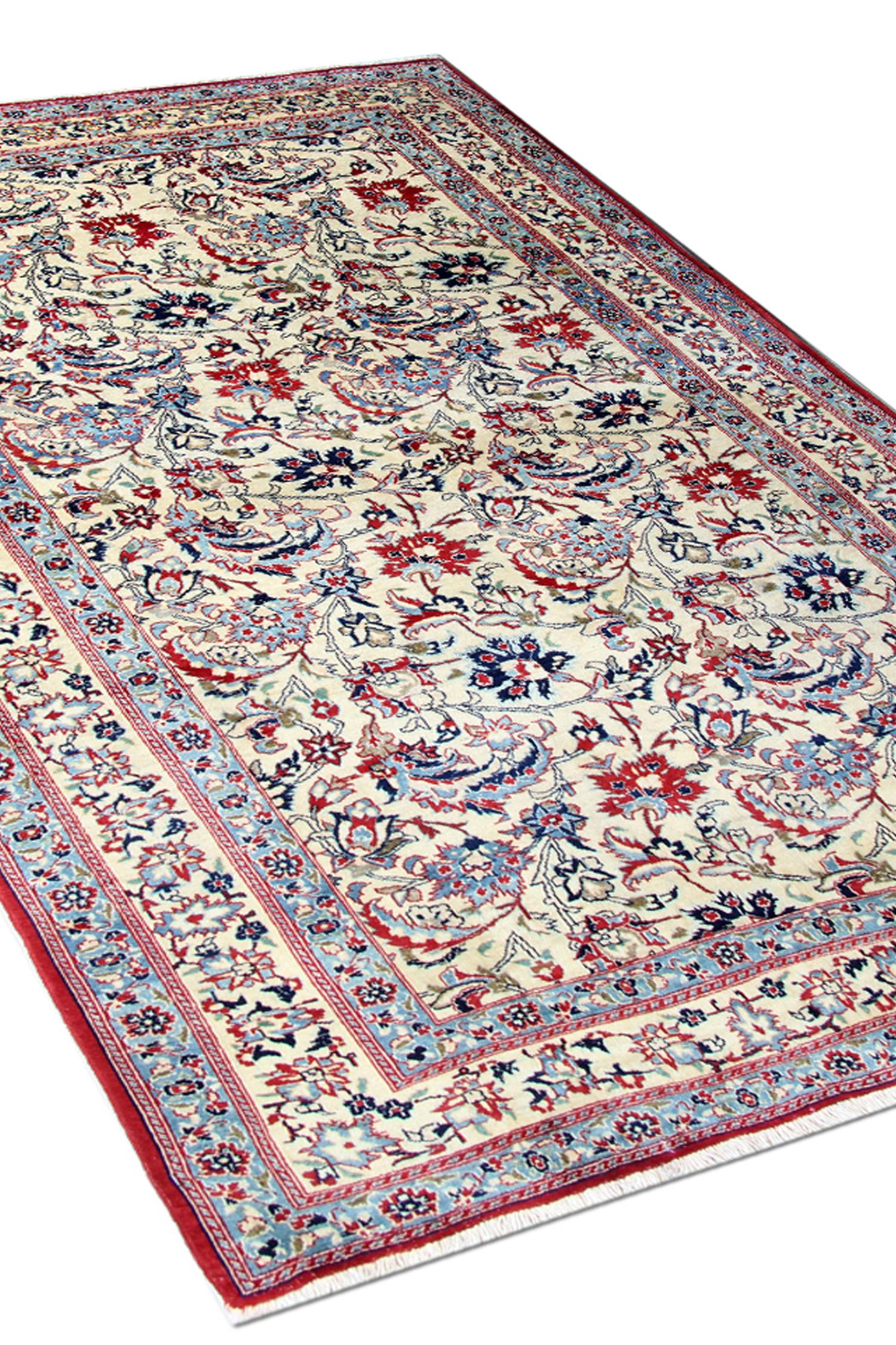 This is an excellent example of old carpets woven in the 1920s. It features an all-over floral design in perfect condition. The design features a bold colour combination of red and blue accents that elegantly contrast against the cream field upon