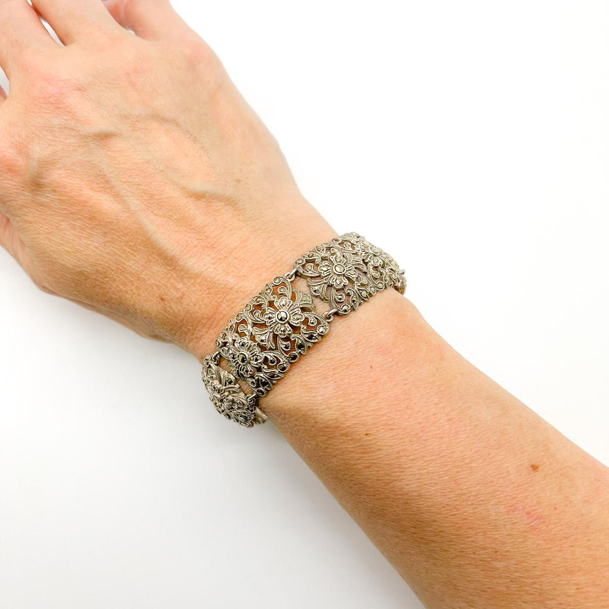 A beautiful Antique floral marcasite bracelet. Featuring a panel style design depicting stylised flowers set with marcasite stones.
An unsigned beauty. A rare treasure. Just because a jewel doesn’t carry a designer name, doesn’t mean it isn't
