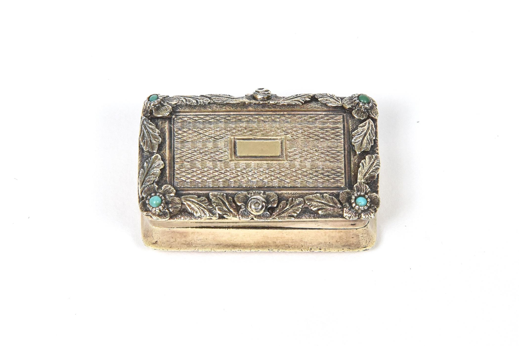 Highly stylized sterling silver vinaigrette, pill or snuff box by famed English silversmith William Simpson circa 1826 featuring a hand hammered raised floral design along the edges with 4 small turquoise accents. The top and bottom of the box are