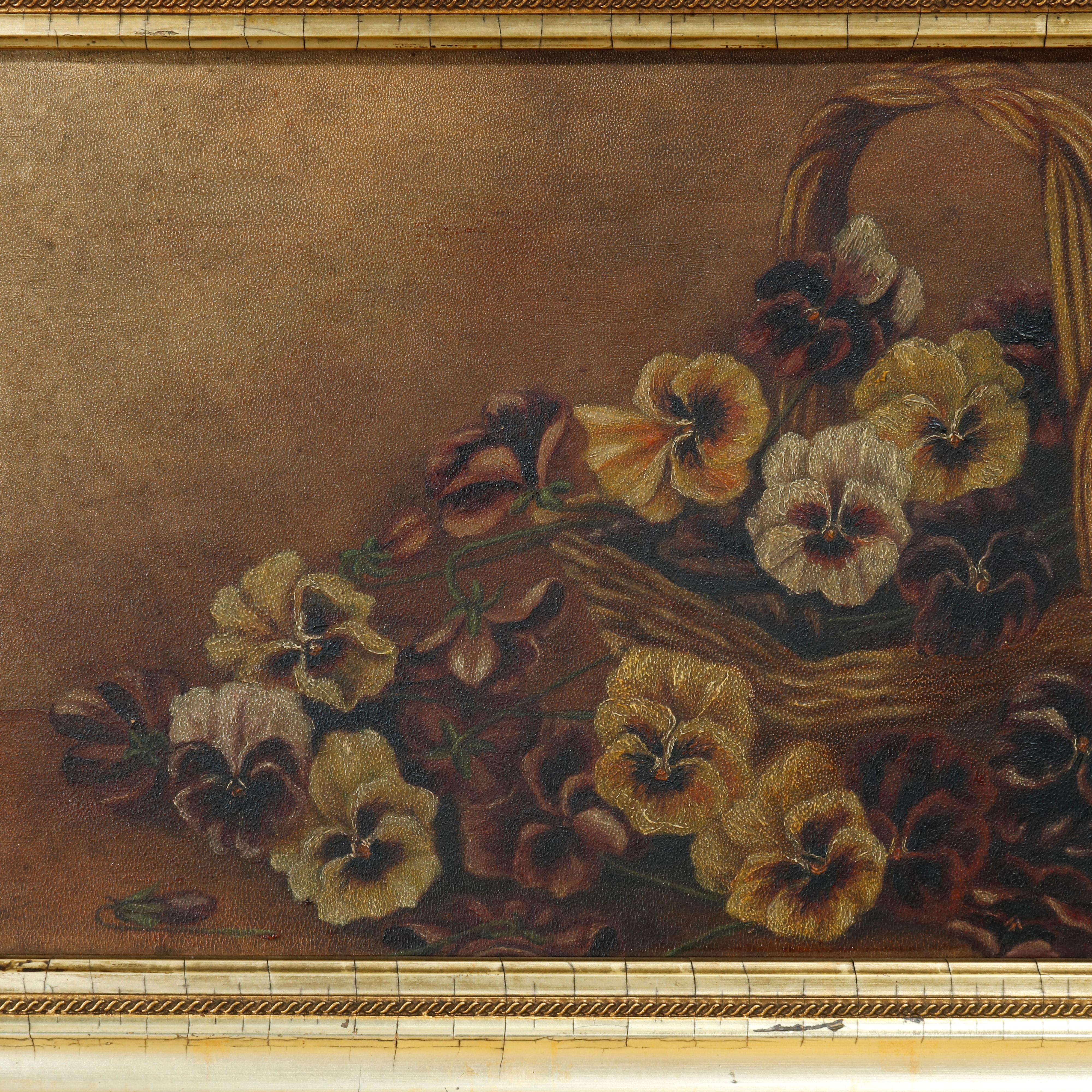 An antique still life painting offers oil on board of a pansy bouquet in a table top basket, seated in giltwood frame, c1890.

Measures: overall 13.75