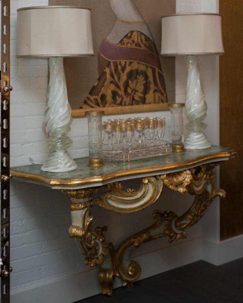 A stunning Baroque Florentine console with magnificent, ornate hand carvings which are painted and gilded. Some of the finest antiques originate from Italy, and this wall-mounted console is no exception. Best suited for a front entry, dining or