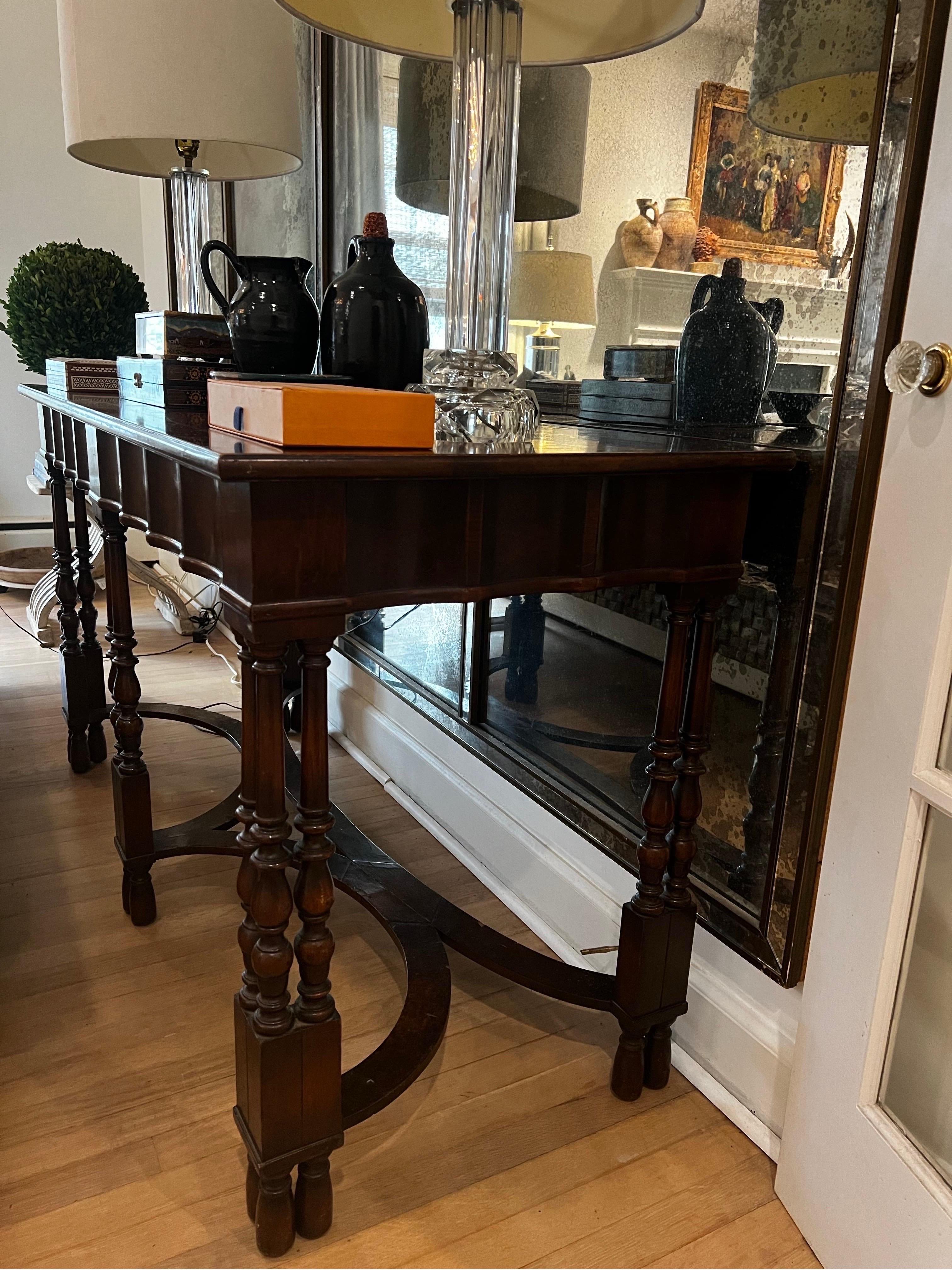 Antique Library/Console Table made by W. & J. Sloane The Company of Mastercraftsmen in the early 1900's. They provided high end pieces for places such as the White House and the Vanderbilts.  

Exotic burled wood veneer inlay on top.  Carved spindle
