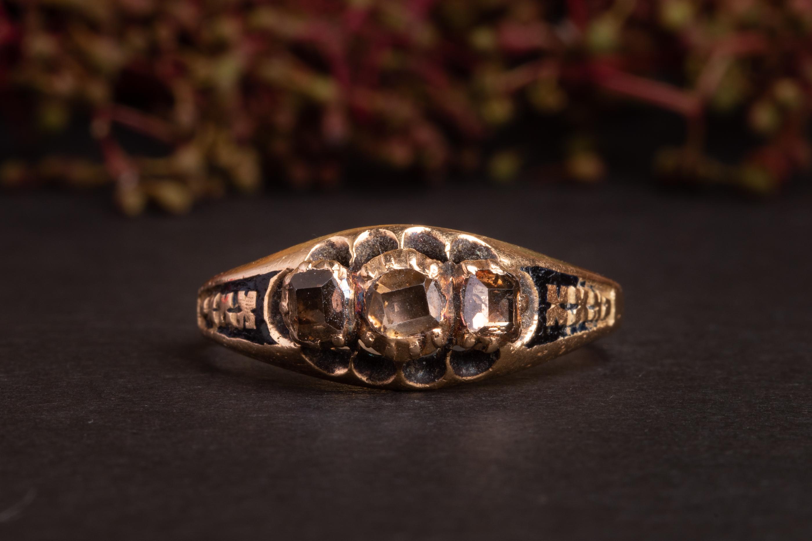 A very old ring of 15 ct gold set with three 'table' cut diamonds. The ring presumably dates to the late 1600's and is preserved in a superb condition.

The shank of the ring is accented with black enamel which has a very minor wear for its age. The