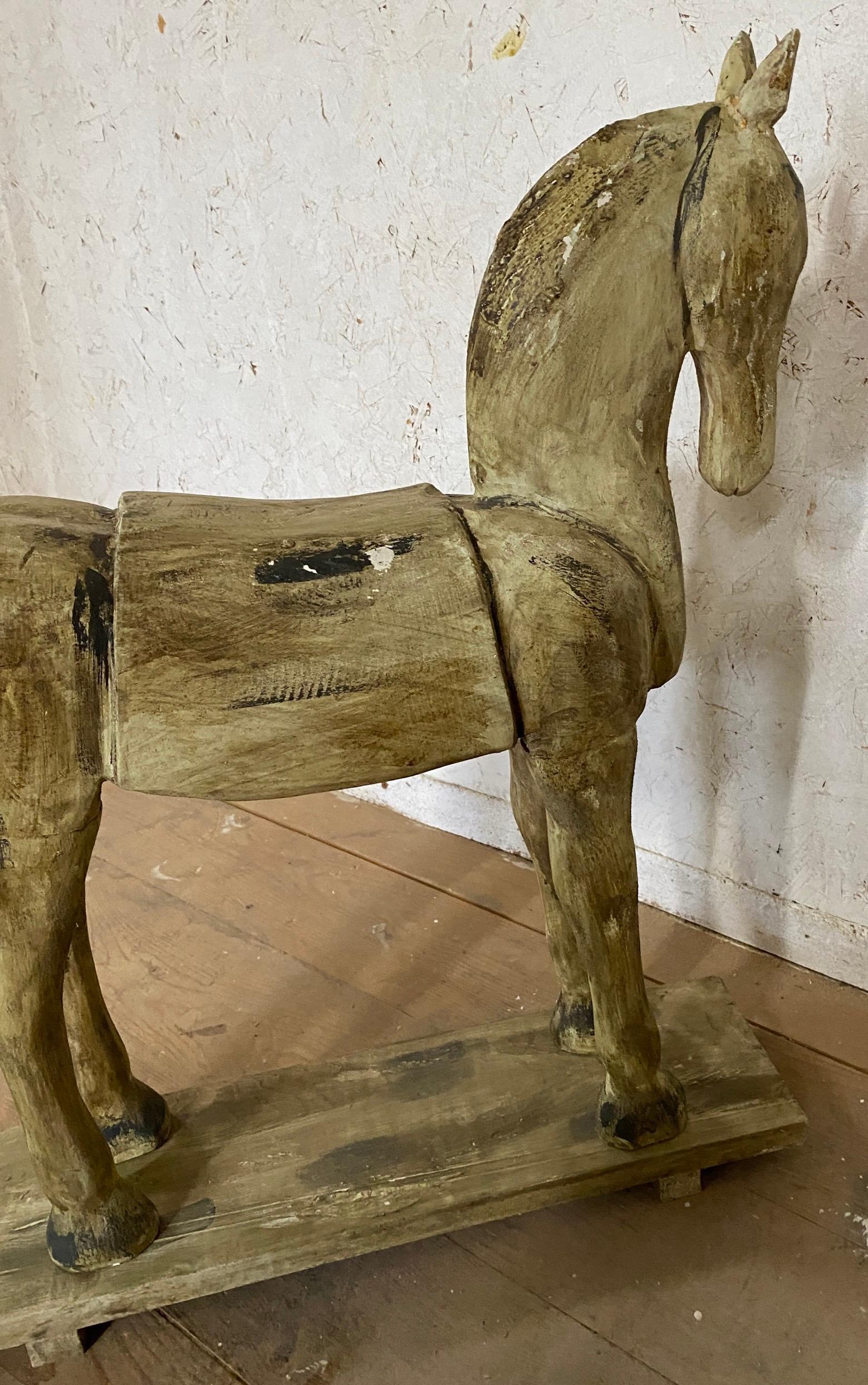 Wonderfully charming hand-carved 19th Century American folk art horse sculpture on stand.  Pay special attention to its face and the carved details to appreciate this fine specimen.  Use it for decoration, display it on a shelf or on the floor. 