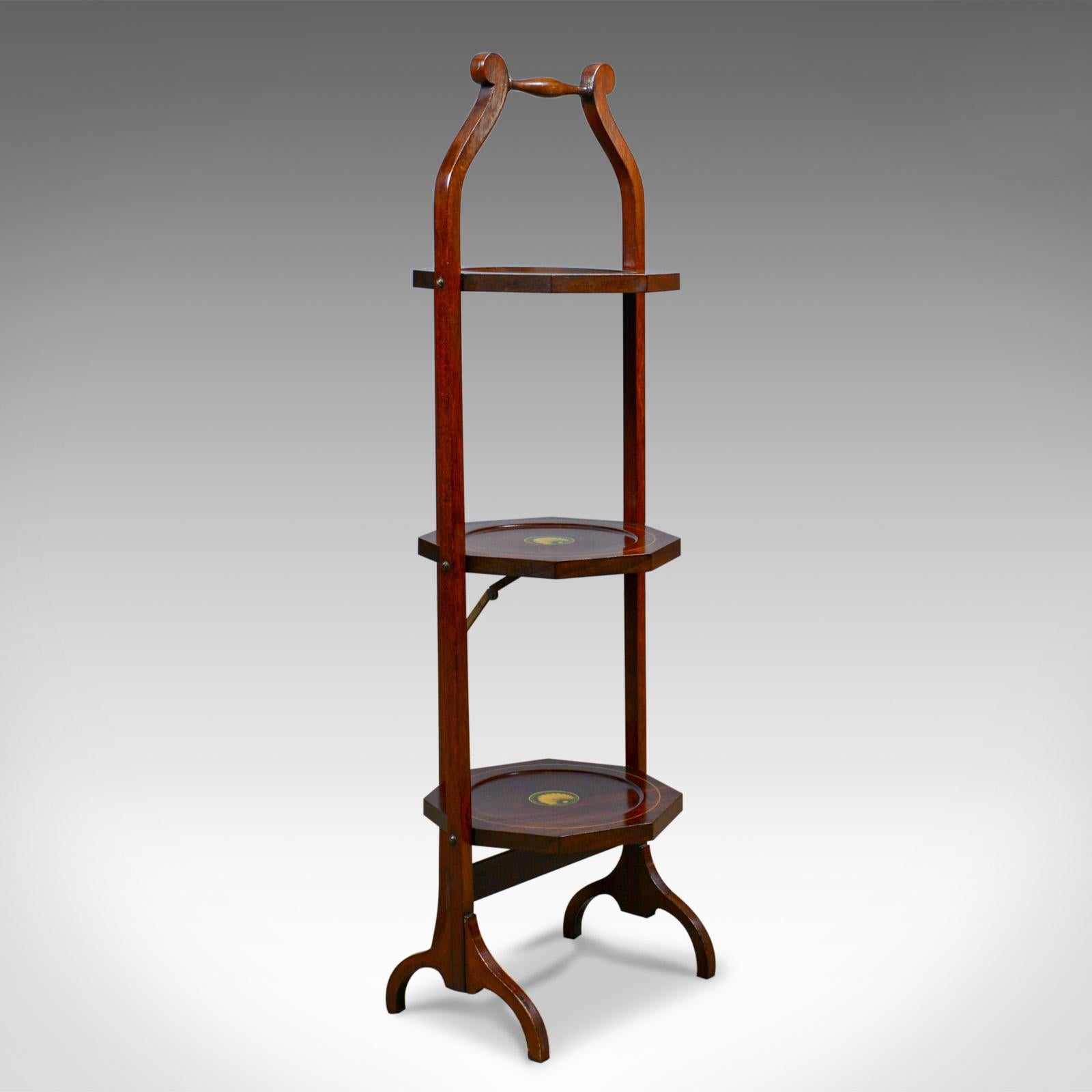 This is an antique folding cake stand, an English, Edwardian, mahogany, three-tier plate stand dating to the early 20th century, circa 1910.

Attractive three-tier form with carry handle
Mahogany glows with a rich, russet hue in a wax polished