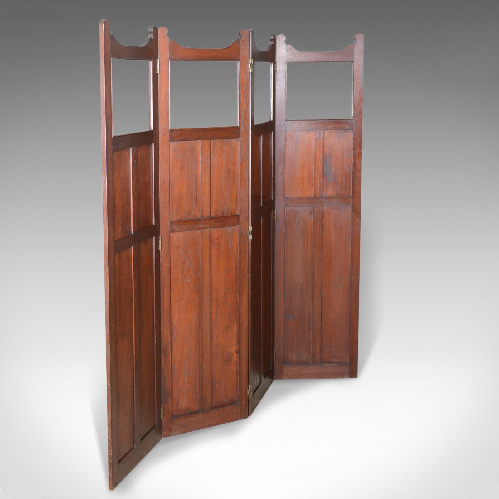 This is an antique folding screen, an English, Edwardian four panel design. A walnut room divider perfect as a photographer's prop, dating to the early 20th century, circa 1910.

Classic walnut panelled design with glazed apertures to the
