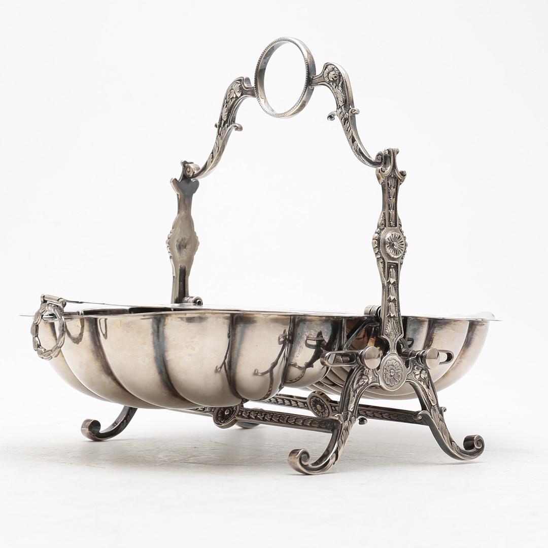 This is a highly decorative Antique Victorian silver plated folding biscuit box, the base bearing the makers' mark of the renowned silversmiths Fenton Brothers of Sheffield, England, circa 1890 in date and bearing the Staniforth's Patent mark as