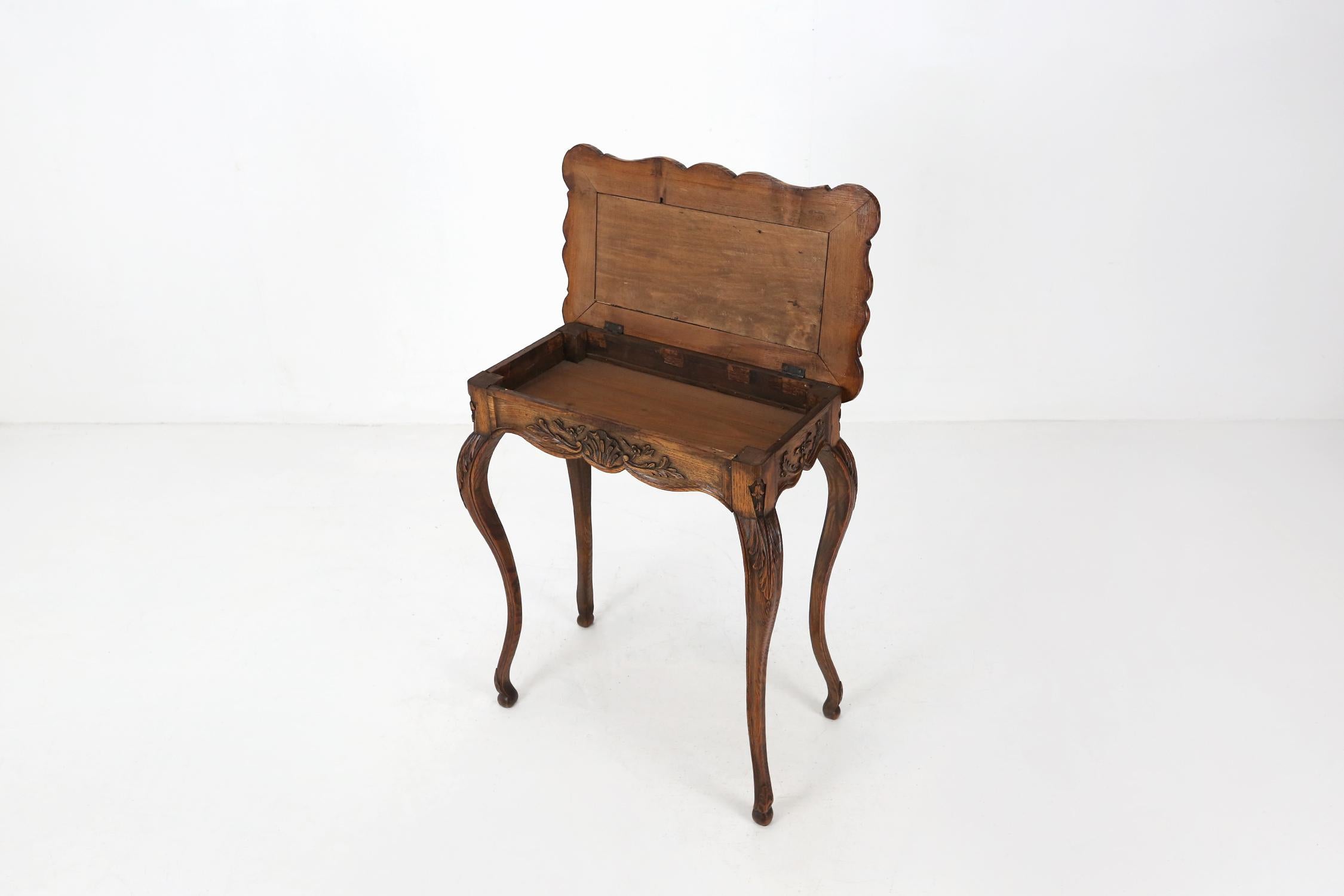 Antique wooden folding side table with some nice sculpture details made around 1900.
