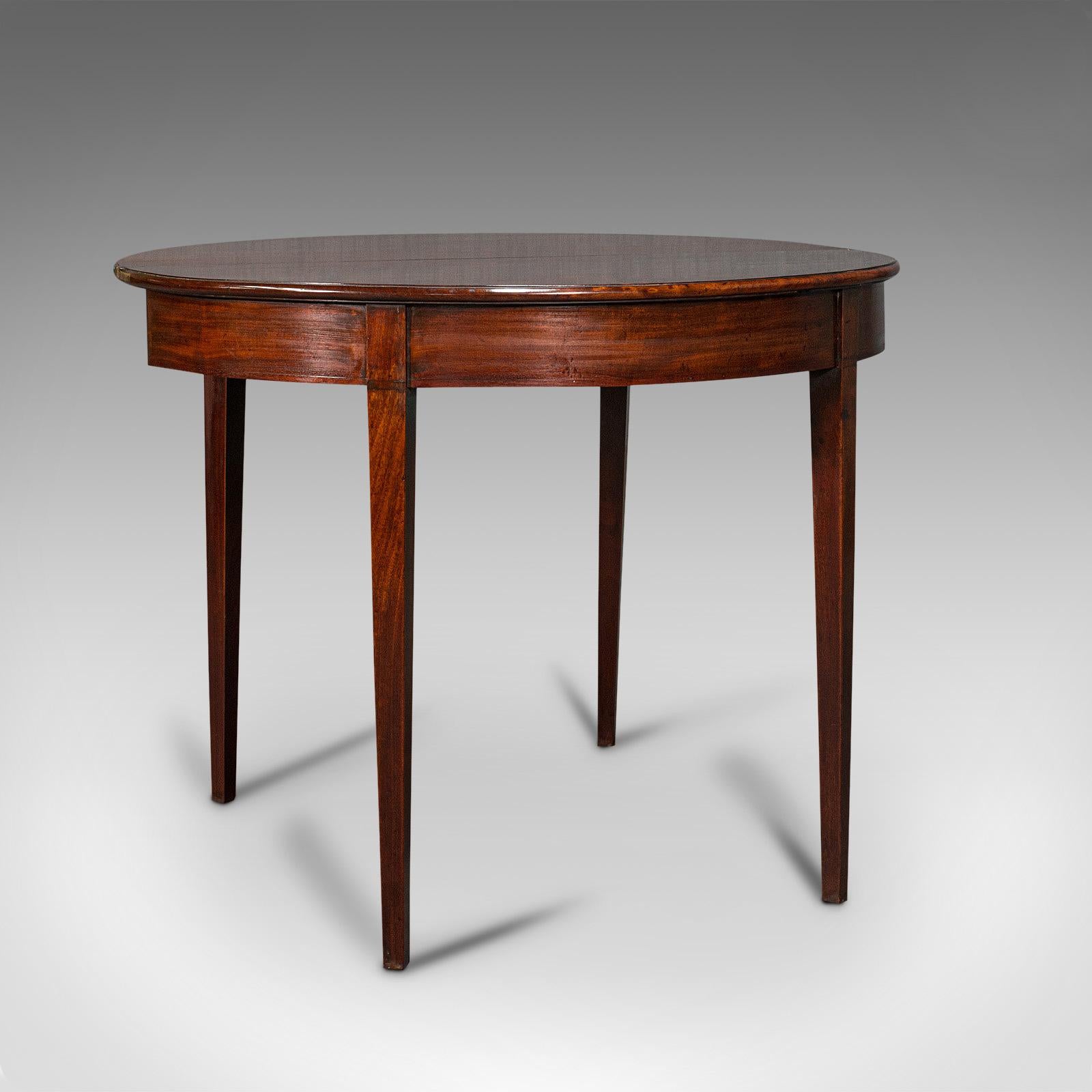 This is an antique folding tea table. An English, mahogany demi-lune side or breakfast table, dating to the Georgian period, circa 1800.

Graced with fine stocks and appealing colour
Displaying a desirable aged patina throughout
Select mahogany