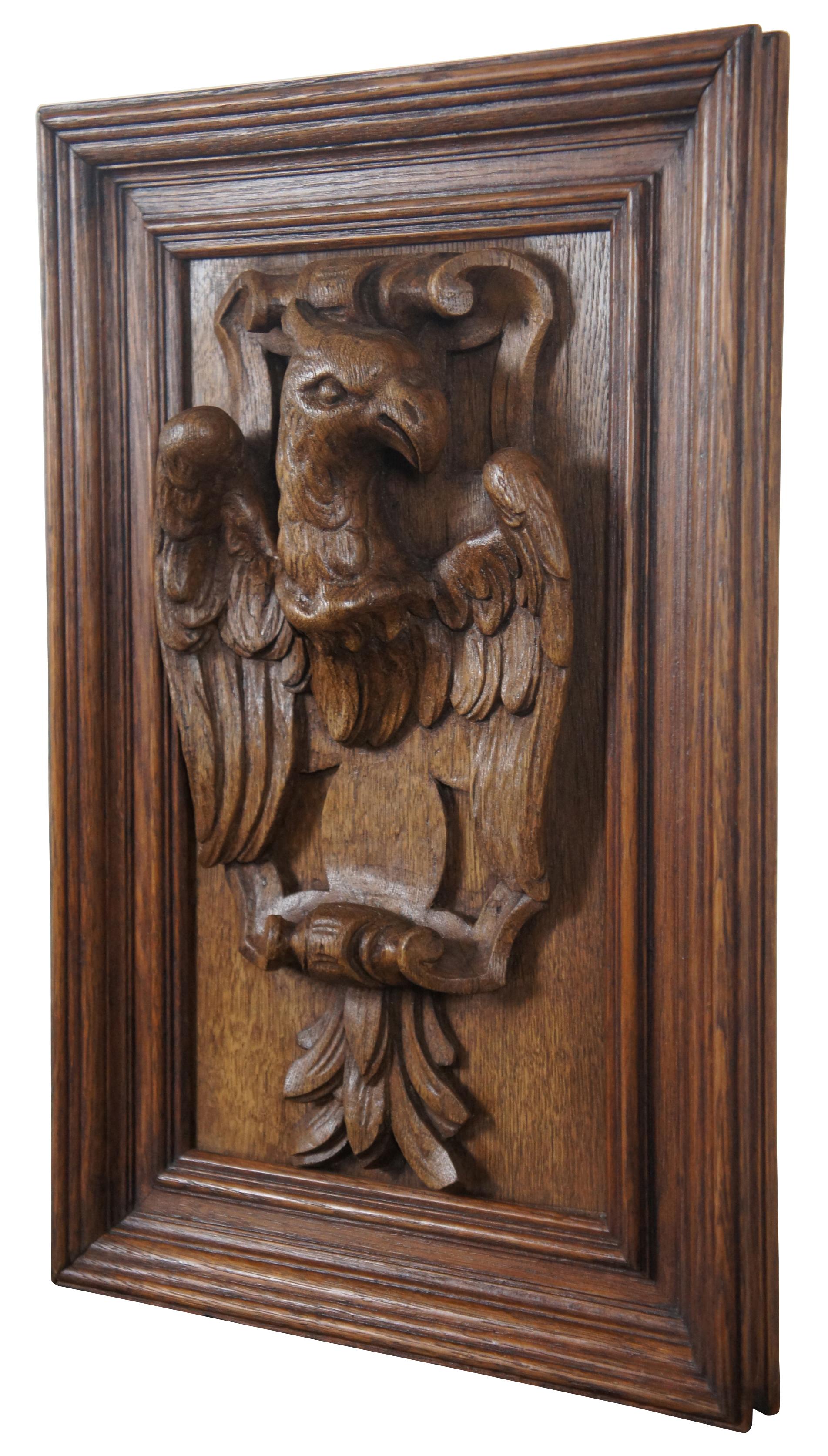 Antique carved oak plaque in beveled frame of an eagle in high relief. Measures: 21”.
  