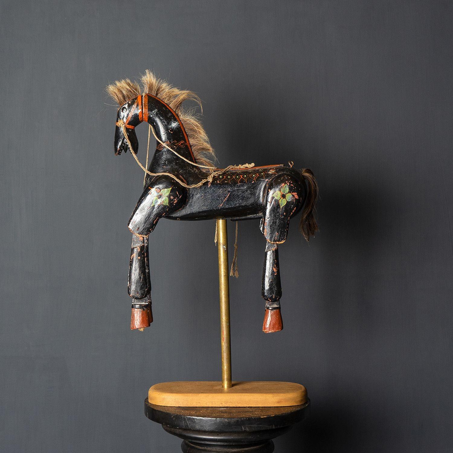 NAIVE CARVING HORSE MARIONETTE
An extremely charming and charismatic depiction of a horse with an attractive paint job and real horse hair mane.
 
This style of carving originated in Northern Europe but and then was taken to America at this time so