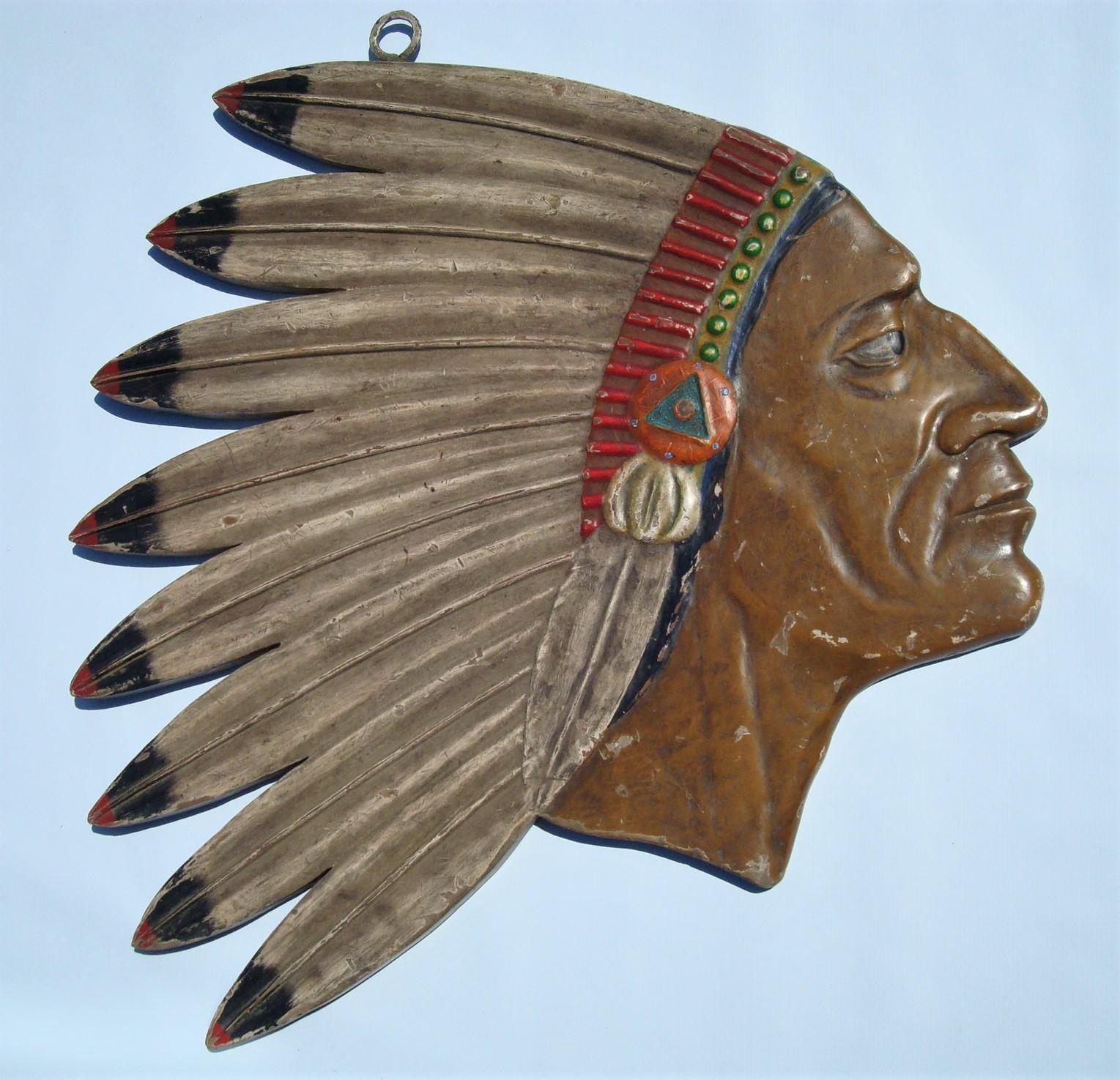 Antique Folk Art Carved Native American Chief Head Advertising Sign. Folk Art Indian Tobacco / Trade Sign.
American, ca 1900´s, painted carved wood with metal hook. A folk art tobacco sign. Relief carved with large profile head of Indian