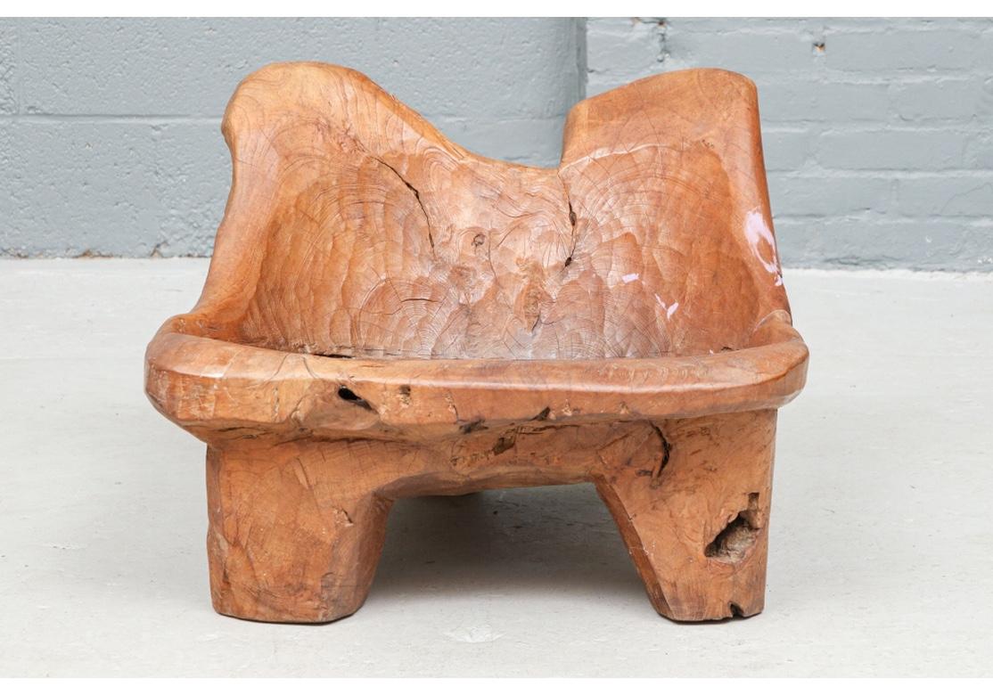 Sculptural and historic wood carving dated 1921. An Organic Form Hand-Crafted Seat in all original very good condition, as much a piece of Sculpture as Furniture. Labeled, “Robbert 1921”. Natural carved tree trunk with short stubby legs and curved