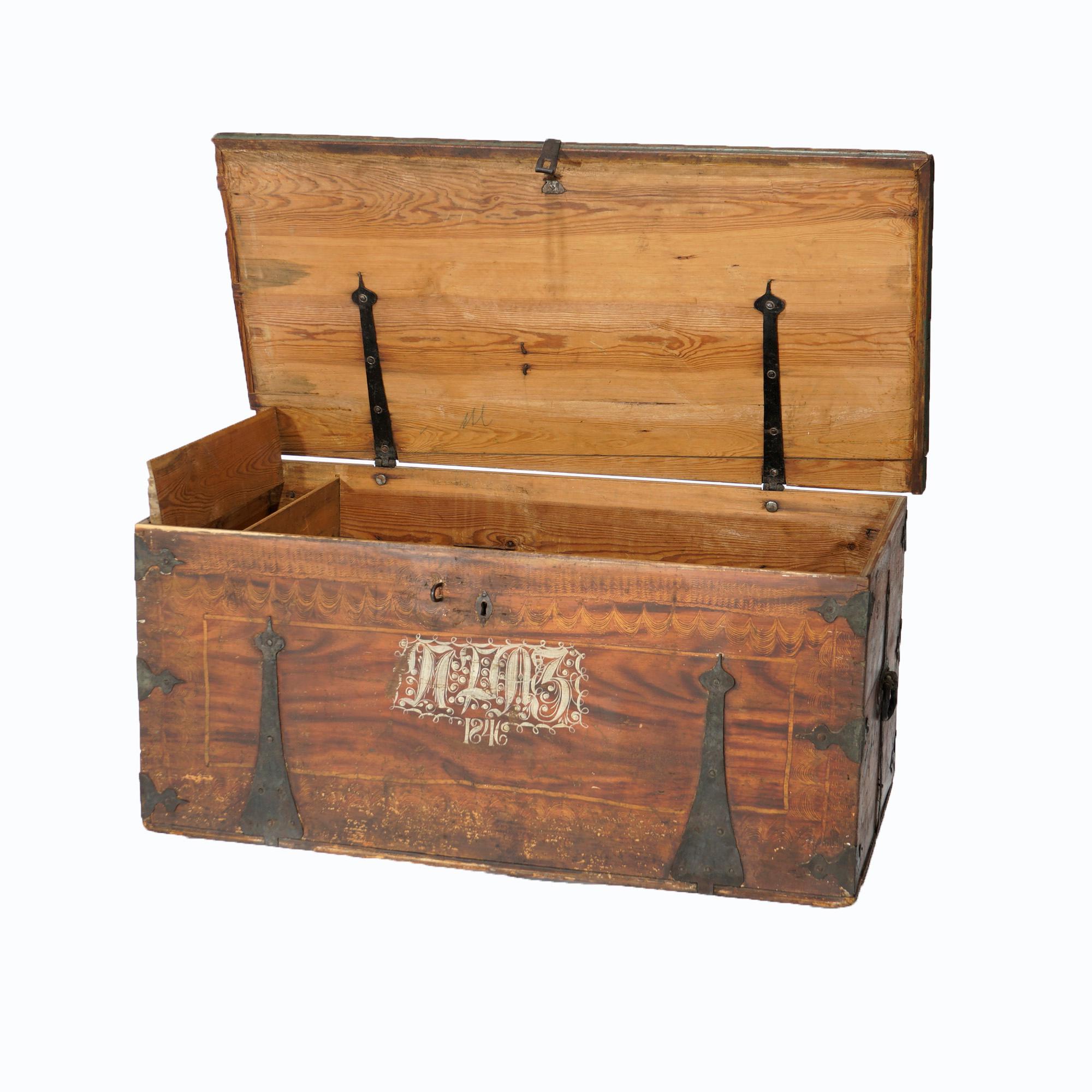 An antique Folk Art blanket chest or trunk offers grain painted wood construction with central date of 1846, strap hinges and interior patch box and drawers as 
 photographed. 

Measures- 20''H x 44.75''W x 23.25''D.

Catalogue Note: Ask about