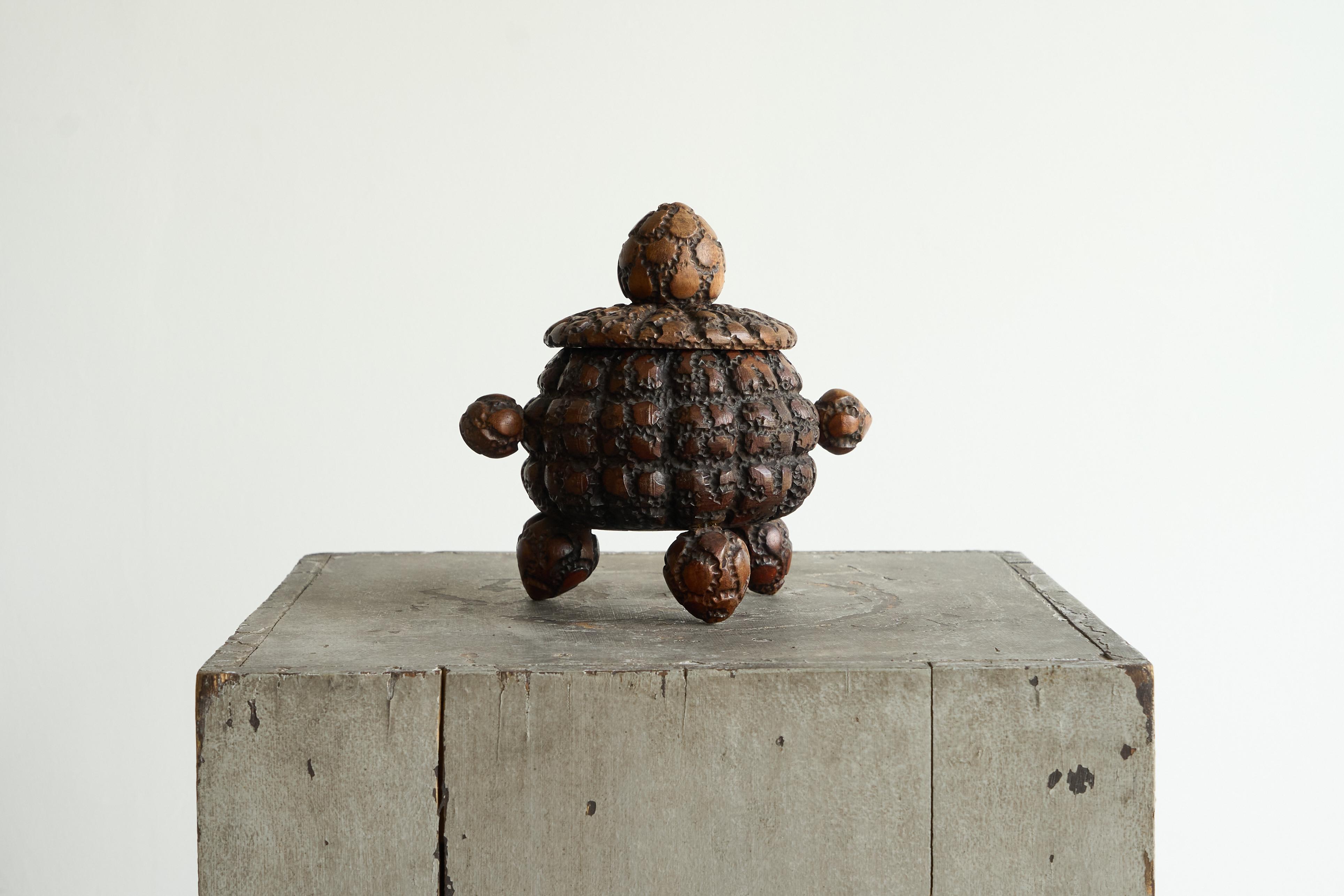 Antique Folk Art Lidded Pot in Carved Wood Early 20th Century.

A great and playful looking lidded pot in carved wood. Great tactile carved surfaces and a very original design with bulky feet and handles. Would work very well in an eclectic interior