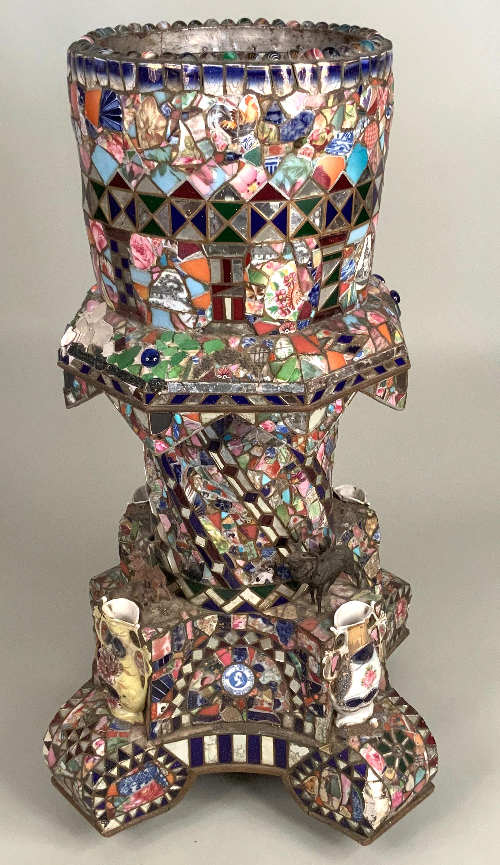 A wonderful and unique antique 1920s 'Memory' plant stand covered entirely in an elaborate mosaic of broken china and pottery. These amazing Folk Art pieces were exceedingly personal and this one especially has more detail than many - with inset