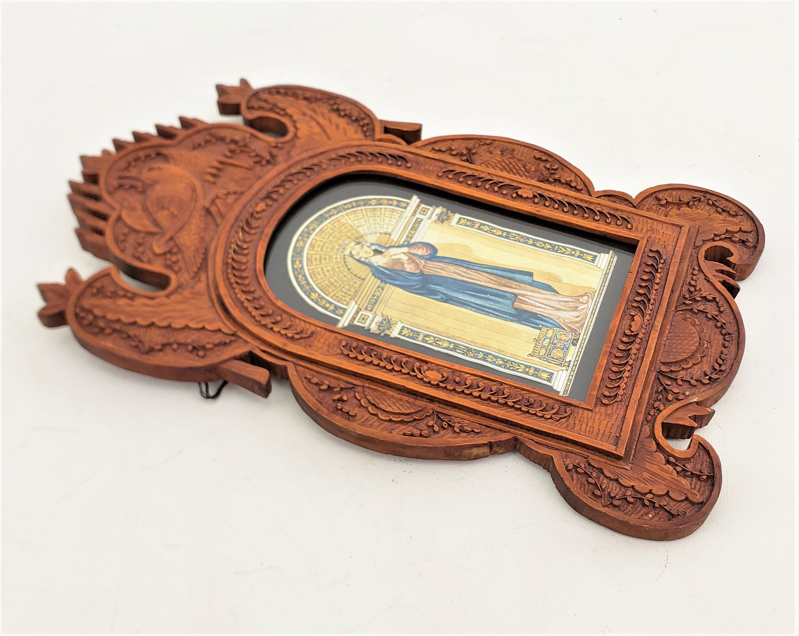 This ornately hand-carved picture frame is unsigned, but presumed to have originated from Eastern Europe, and date to approximately 1920 and done in a Folk Art style. The frame is composed of a softwood which has been elaborately carved with a bird