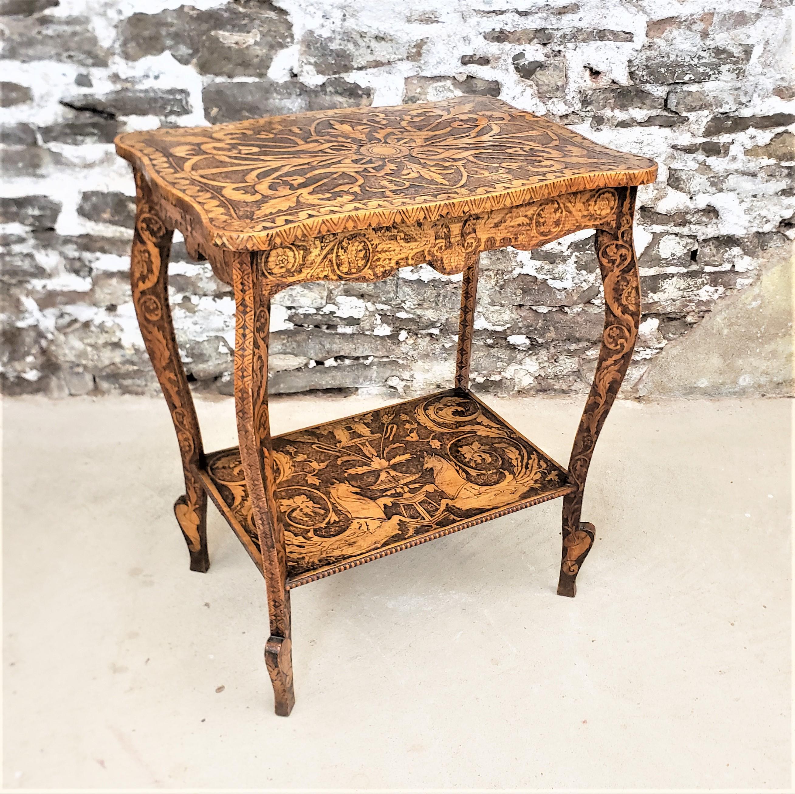 This antique Folk Art pyro decorated two tiered table is unsigned, but presumed to have been made in the United States in approximately 1900 in the period Folk Art style. The entire table, including the skirt and the sides of the legs in addition to