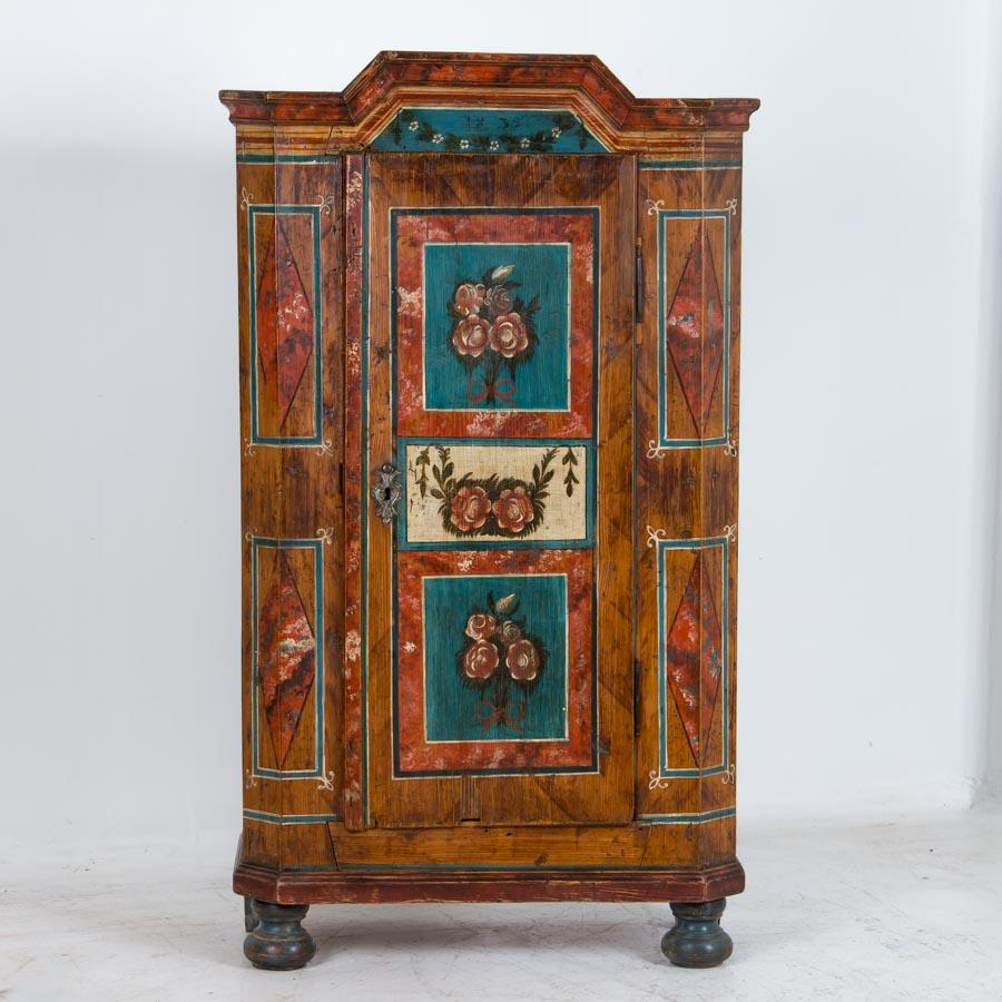 It is always a joy to discover a truly beautiful, original painted armoire and this one is an exceptional find. The skill of the painter is still seen today, revealed in the aged yet vibrant colors and wonderful detail in the flower motifs and