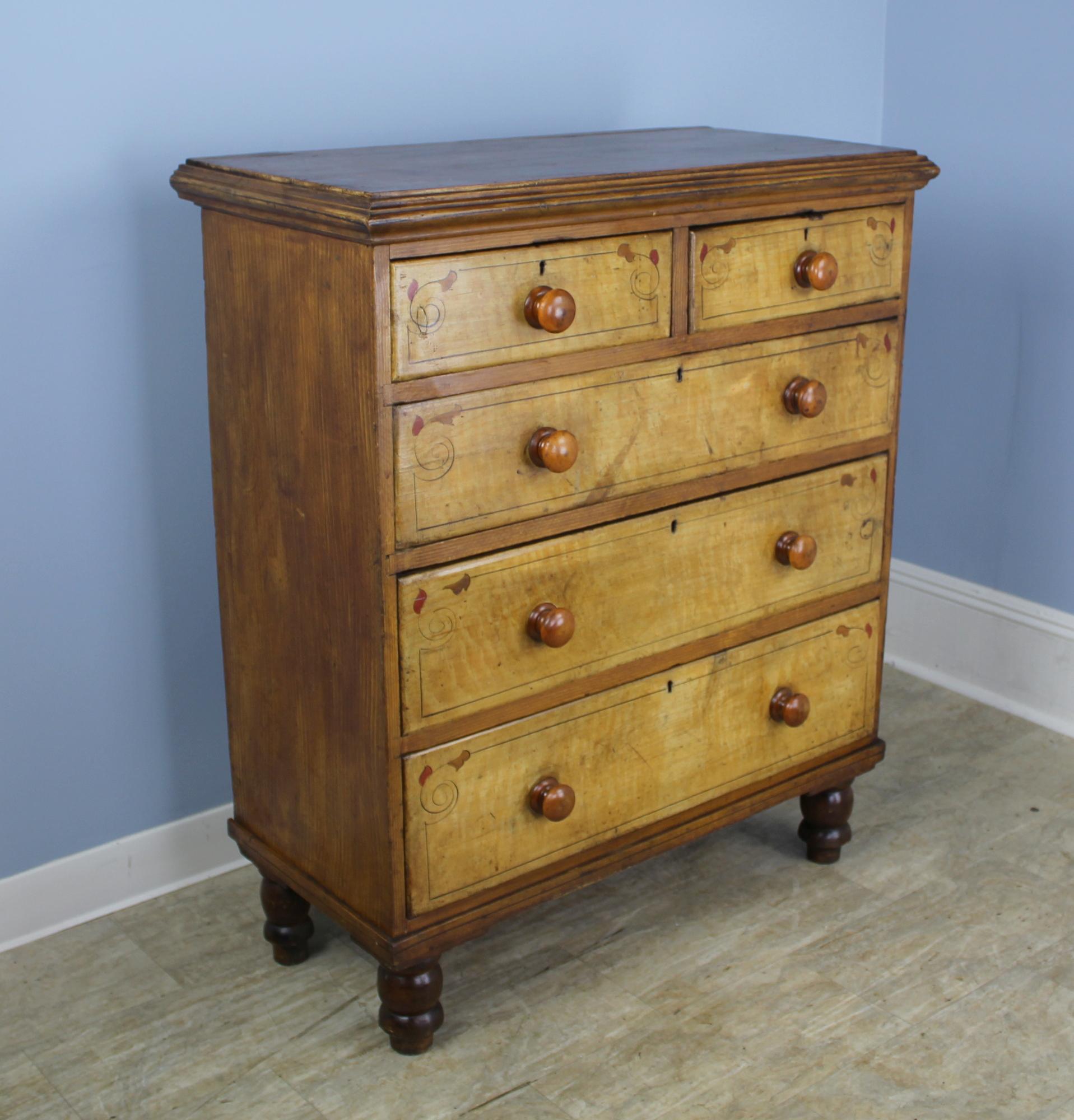 A whimsically hand painted honey colored pine chest of drawers. Charming molded top and bun feet. Drawers are clean and slide easily.