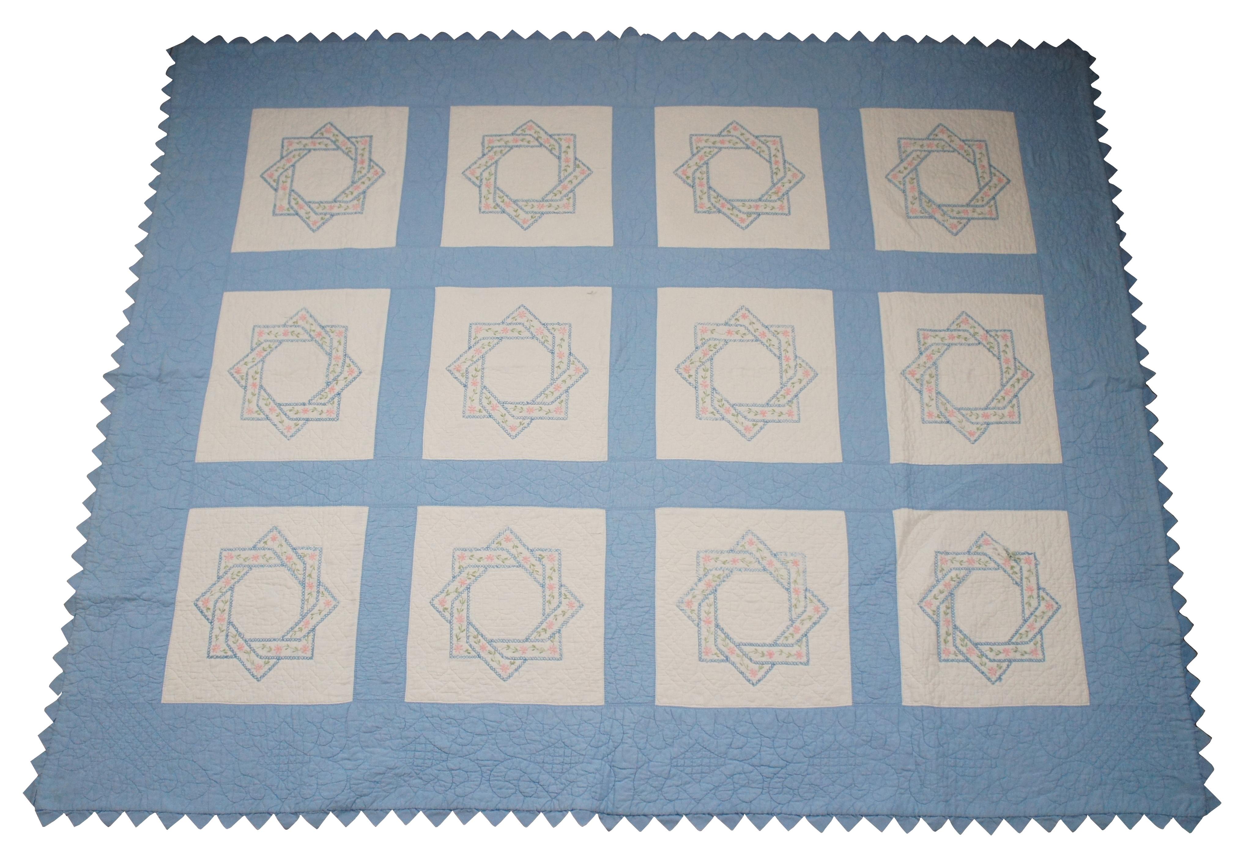 Antique hand stitched blue and white bedspread / blanket / coverlet / quilt with sawtooth border and blocks embroidered with woven interlocked eight pointed stars lined in pink flowers. Measure: 91