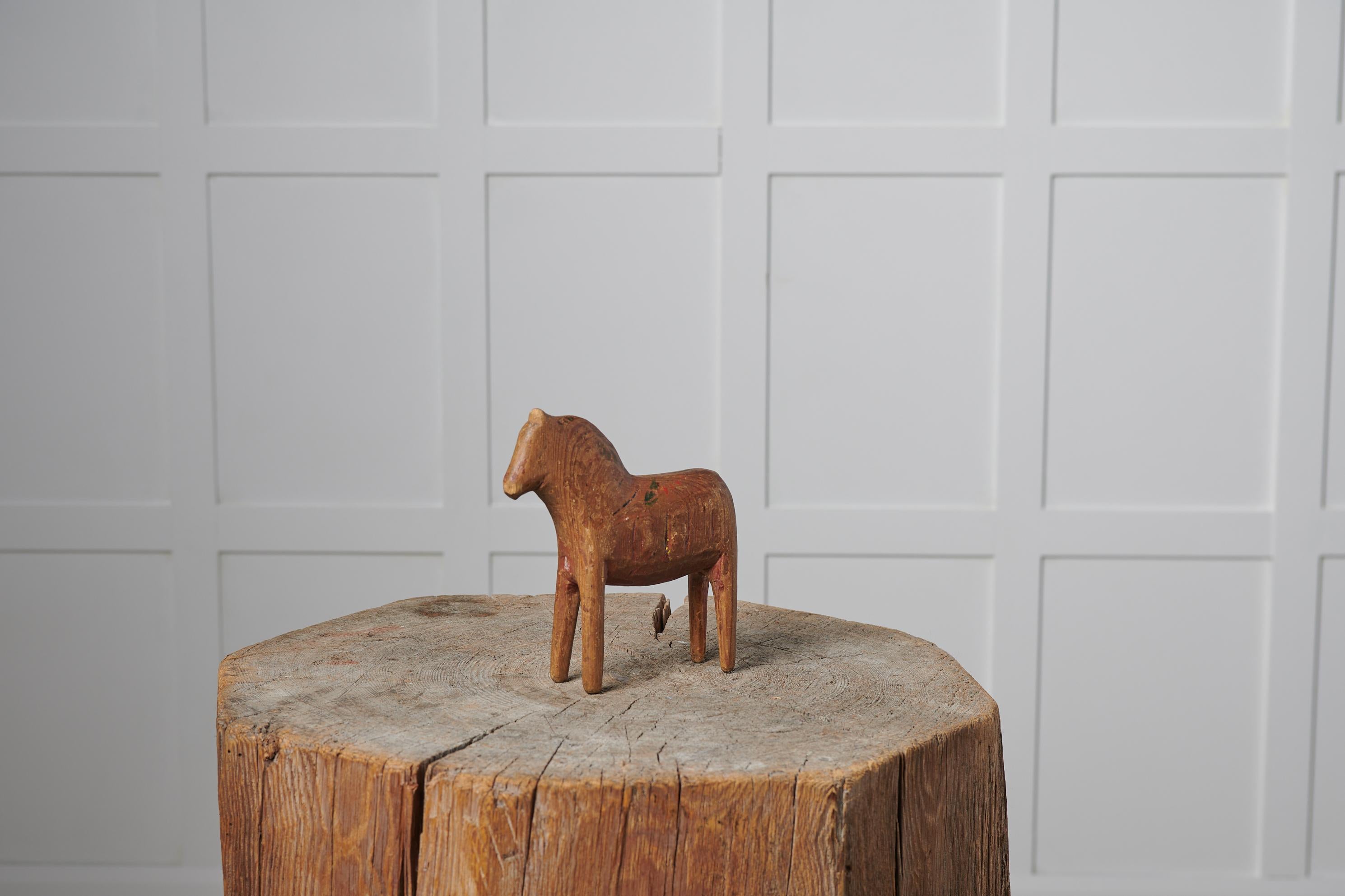 Antique hand-made toy horse in folk art from Sweden. The horse is from the late 1800s and in good vintage condition with traces and marks of use. The horse is made by hand in pine and has the warm patina of aged wood.