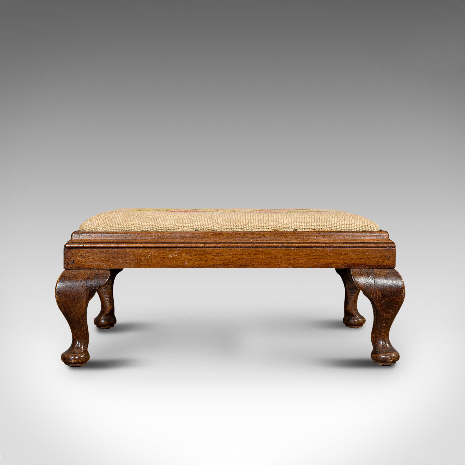 This is an antique foot stool. An English, mahogany and beech drop-in footstool with needlepoint tapestry, dating to the Edwardian period, circa 1910.

Appealing Edwardian craftsmanship
Displays a desirable aged patina
Mahogany and beech show