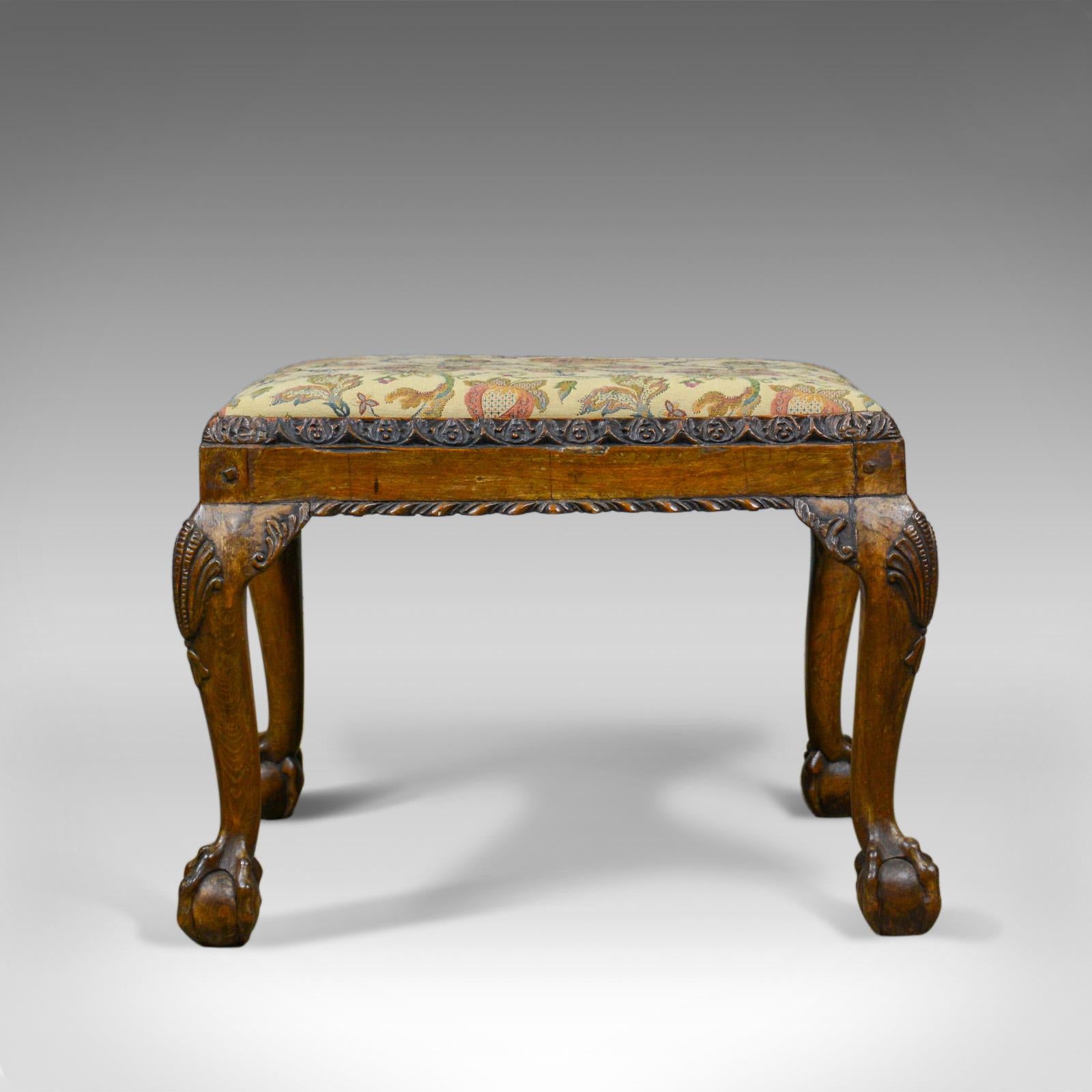 This is an antique foot stool in walnut with a needlepoint tapestry cloth. An English provincial stool dating to the Regency period of the early 19th century, circa 1820.

Deep, warm tones to the walnut frame
Desirable color and an aged