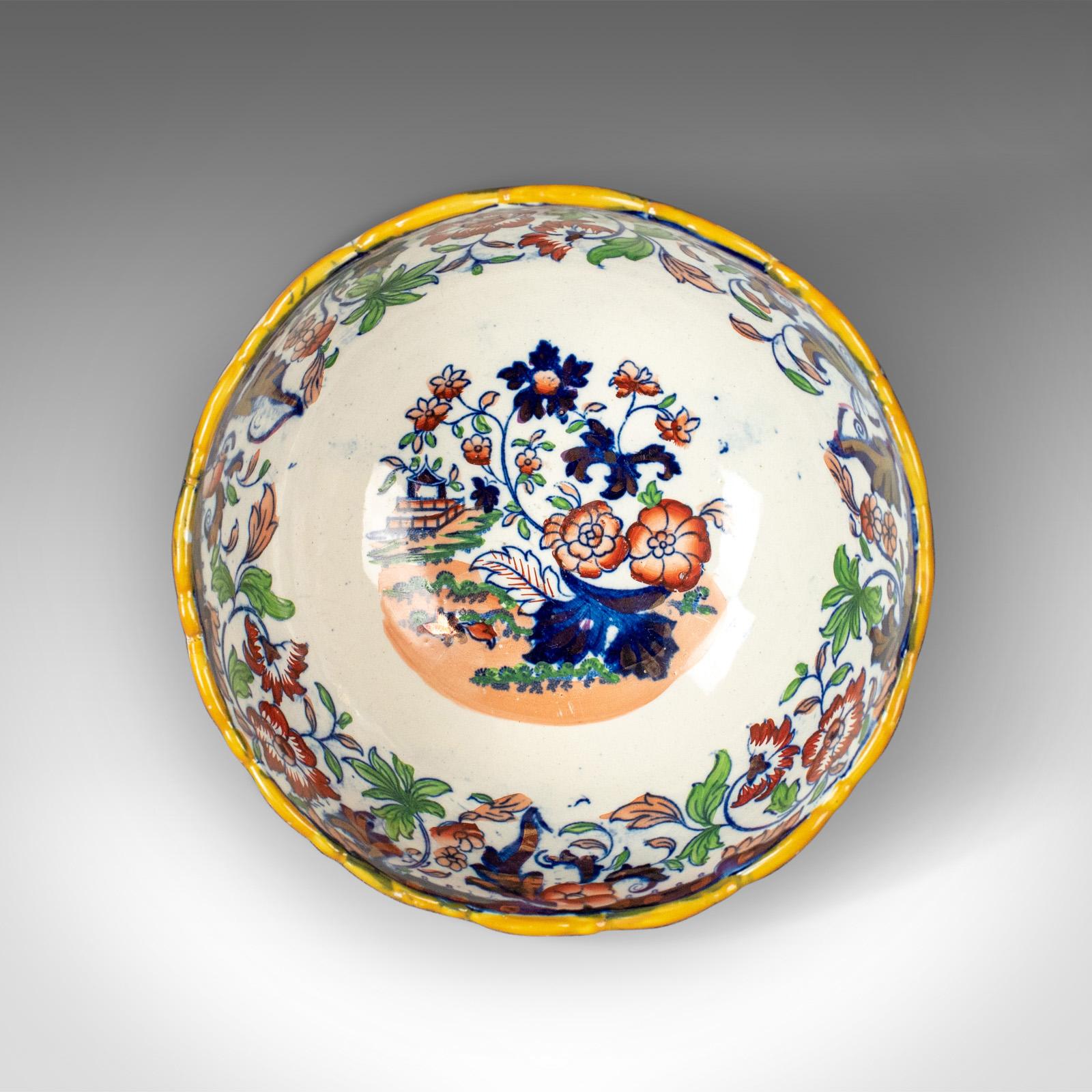 This is an antique footed bowl in blue, white and ochre. An Amherst Japan ironstone fruit bowl, made in England, circa 1900.

An attractive bowl in good condition throughout
Painted with floral and foliate detail with an ochre rim
The theme