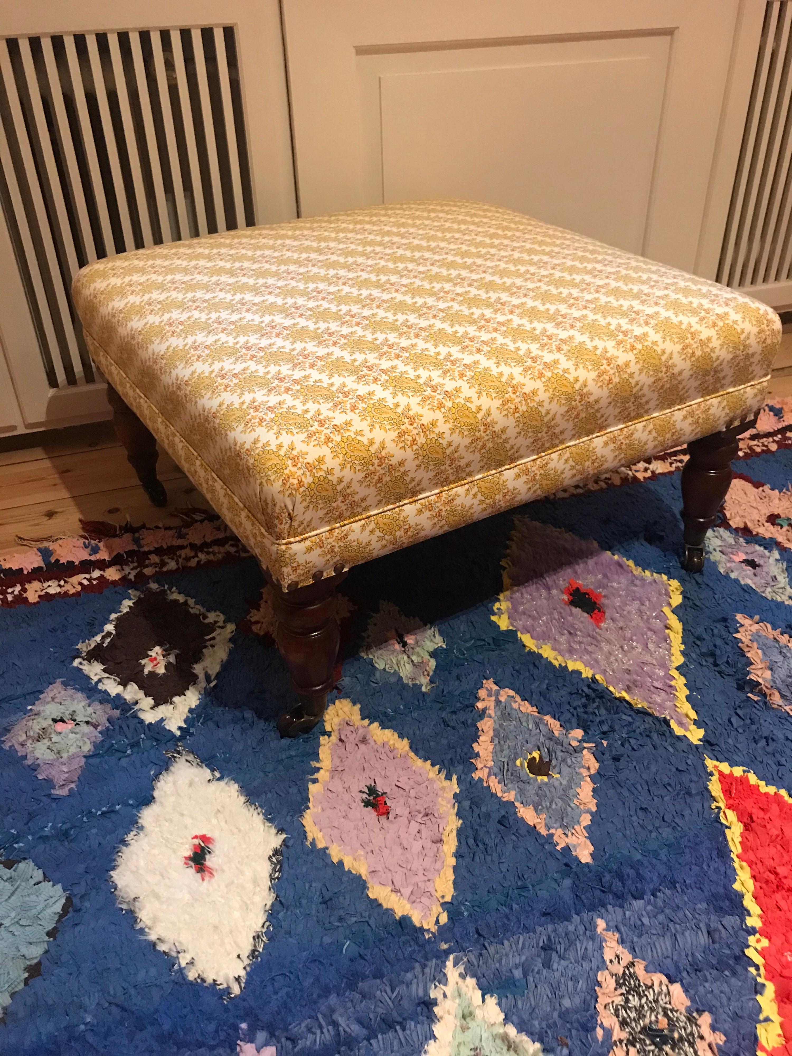 Beautiful antique footstool from the late 1800. Newly reupholstered in parsley fabric (linen).