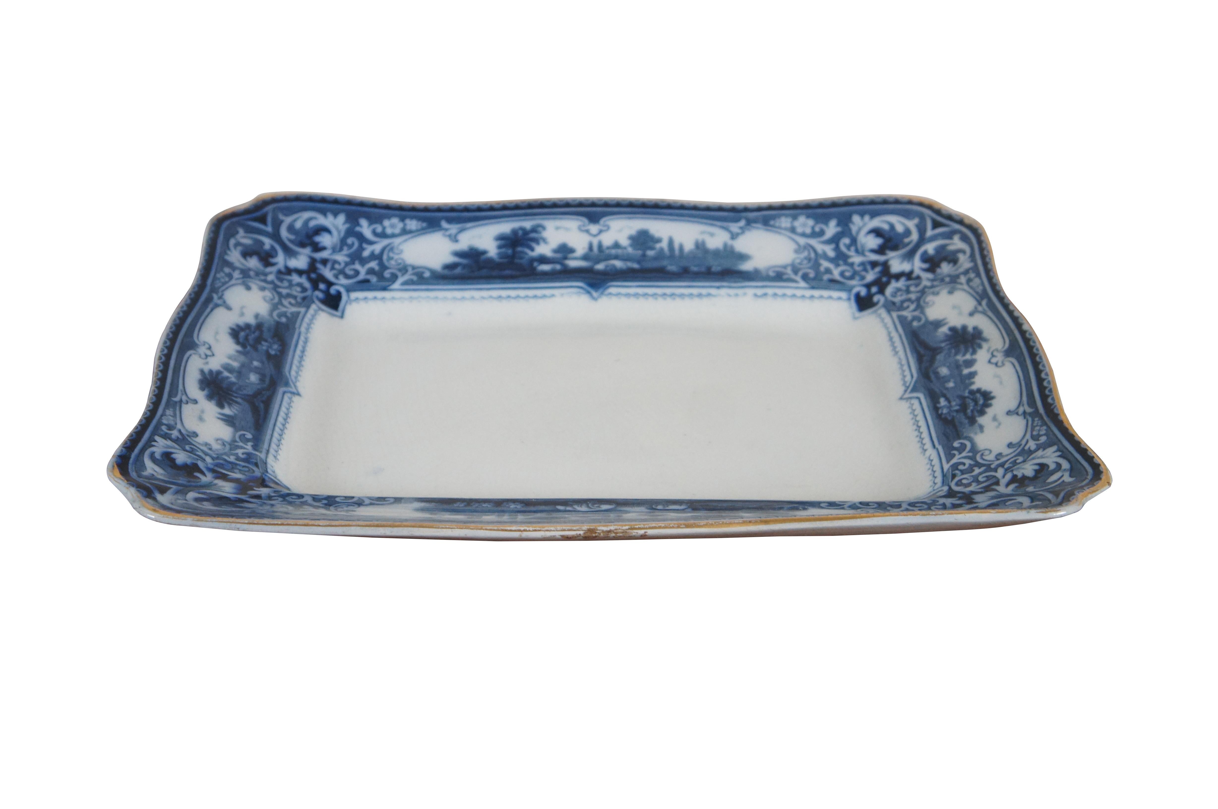 Large antique circa 1908-1913 Ford and Sons Ltd of Burslem, England Verona pattern ceramic serving platter featuring a slightly scalloped rectangular shape, gilded edges, and a blue transferware including floral and foliate designs framing pastoral