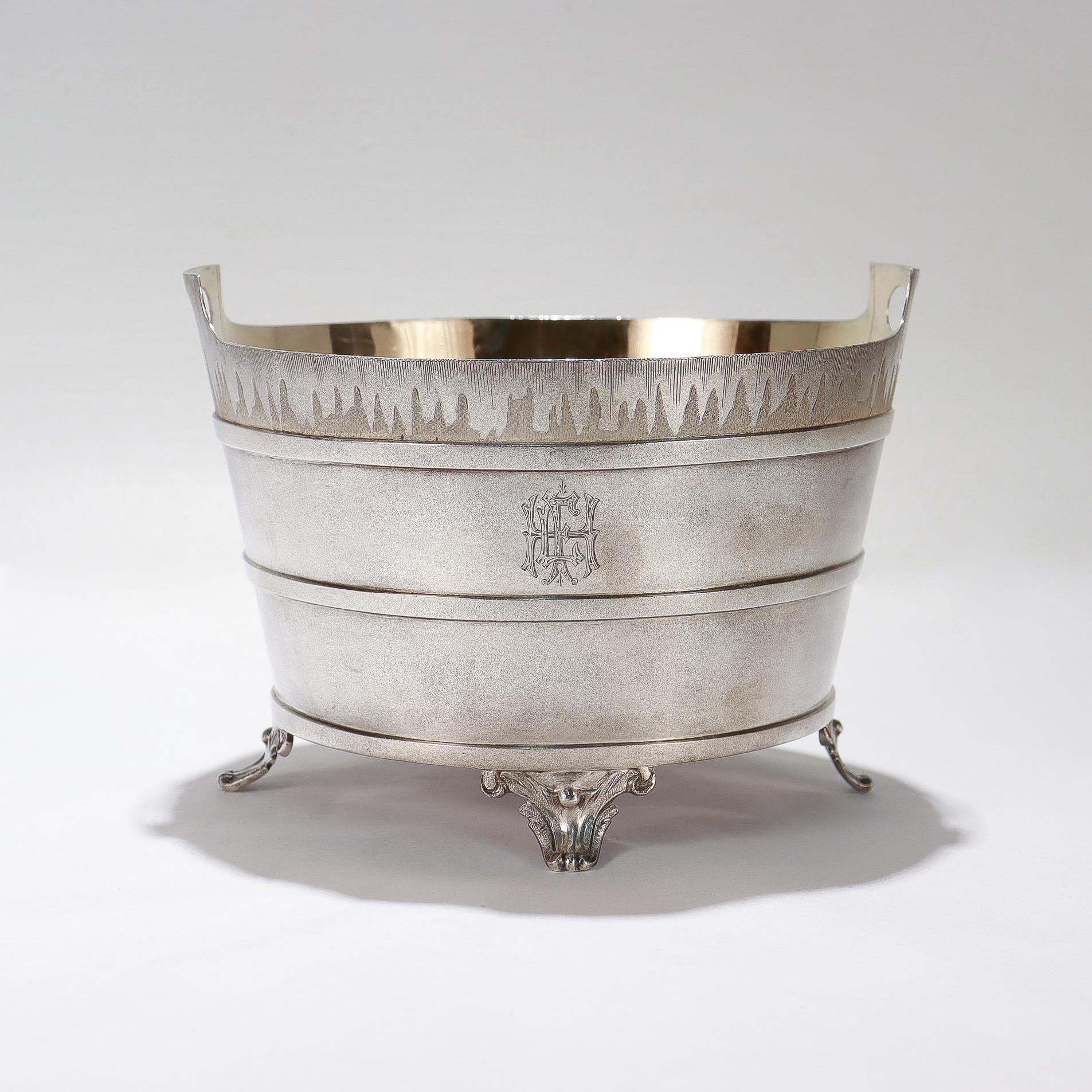 Fina cubitera figurada americana de la Edad Dorada.

Por Ford & Tupper, los renombrados plateros neoyorquinos del siglo XIX. 

Con forma de cubo o barril con asa. 

Con interior y pantalla de hielo bañados en oro, decoración de escarcha estilizada