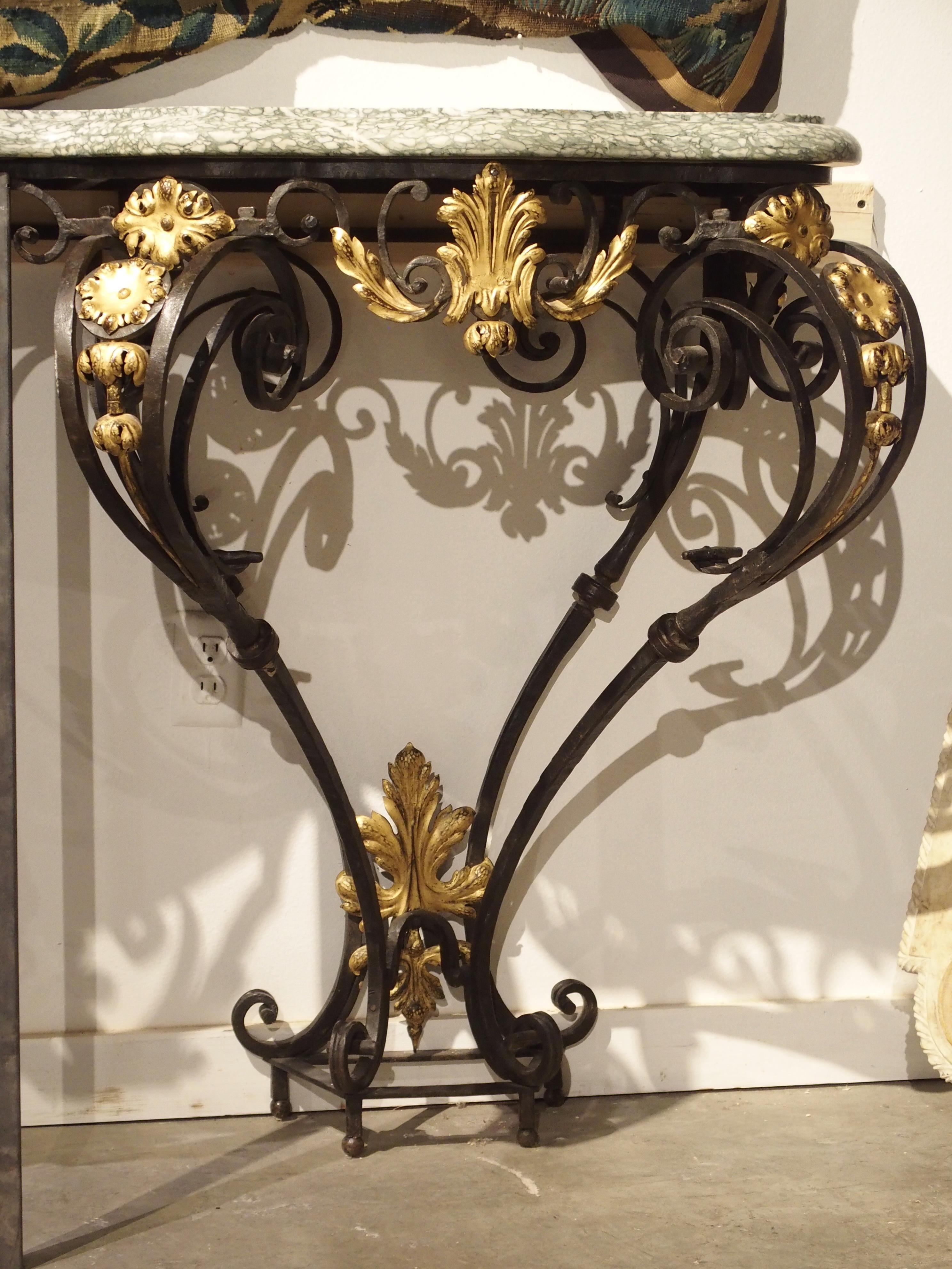 Vertical bars in front of console are temporary display supports due to back wall instability (not part of console table)

From France, this magnificent hand wrought iron, marble and gilt tole console table was made in Provence, circa 1850. The