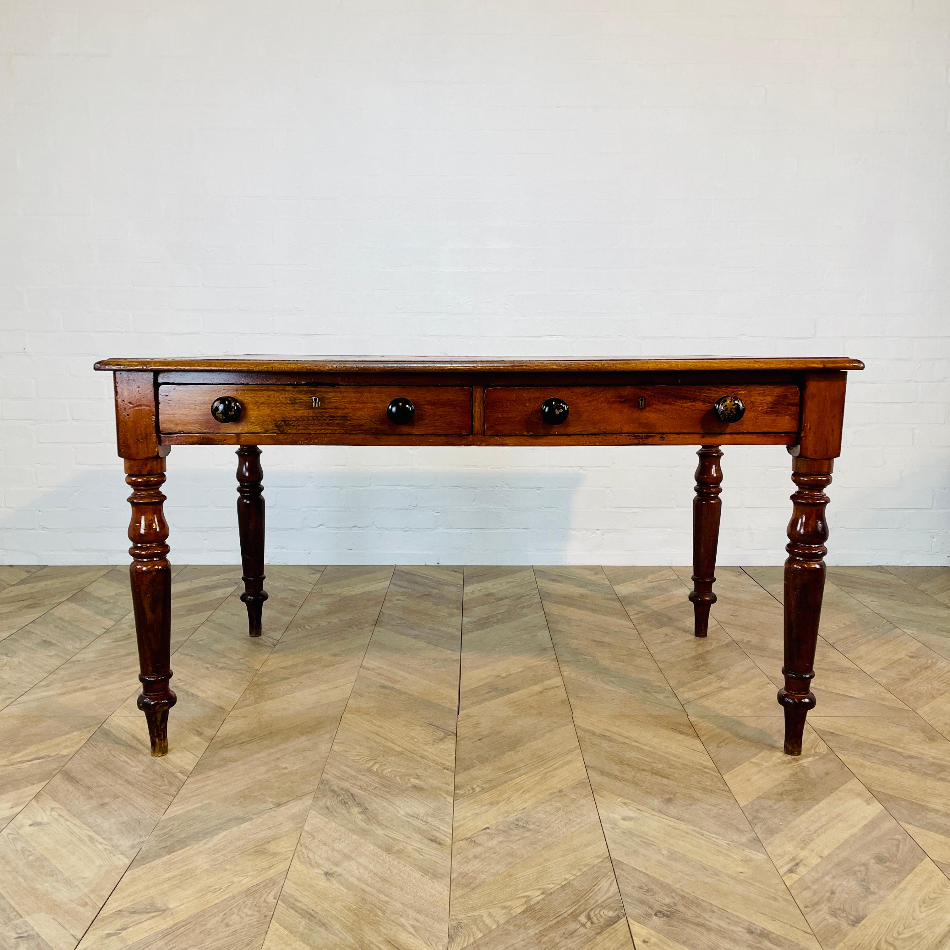 A Beautiful Antique Oak Table with Two Drawers, circa 1890s.

The table originated from the University of Cambridge and was formerly used as a Library table and boasts a red leather top on turned legs.

The table is in good antique condition with