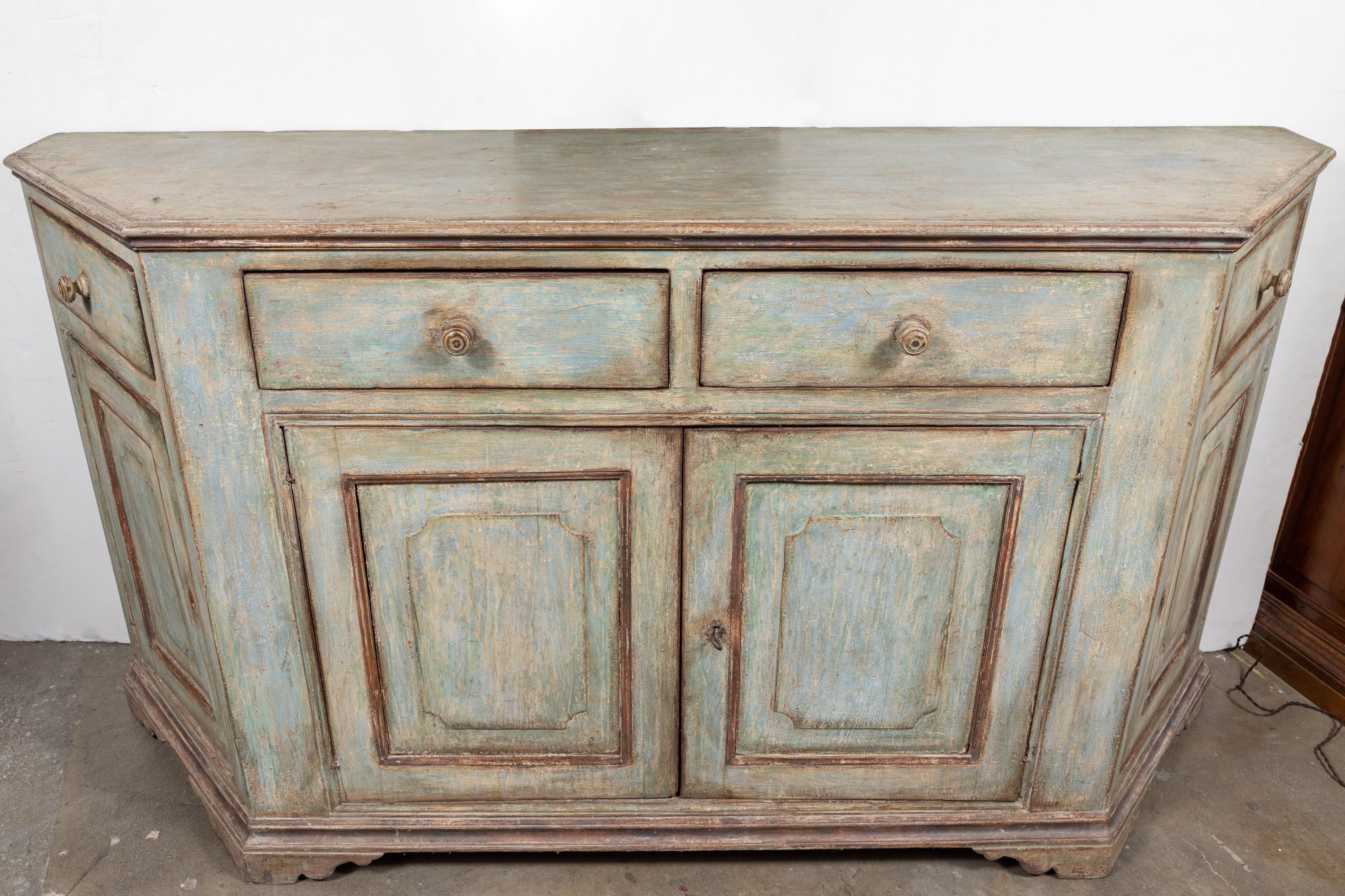 Large, 19th century, canted corner, four-over-four, hand carved Tuscan buffet in later paint.