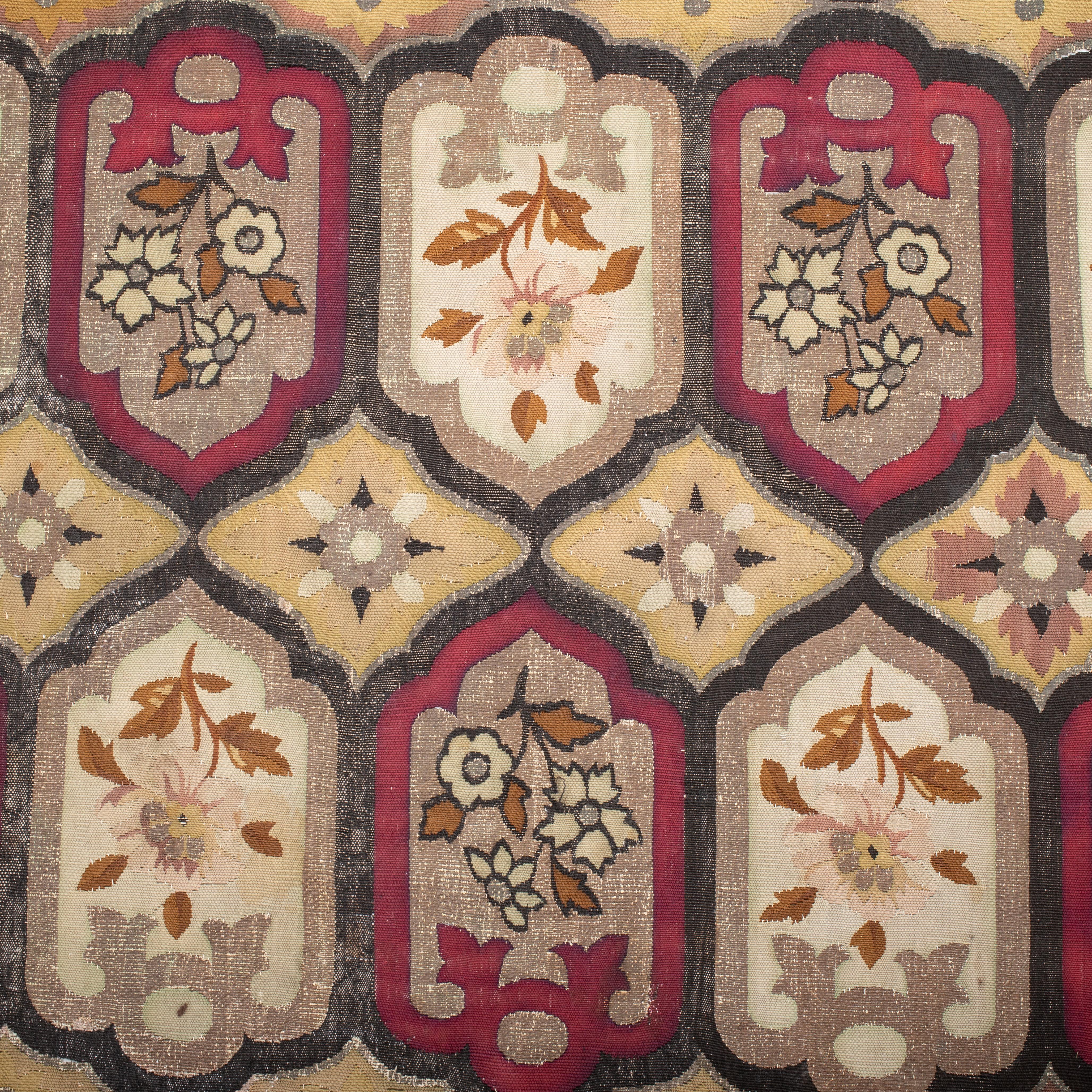 A large fragment from an early 19th C. French tapestry woven in wool and metallic thread.
Some of the corroded parts have been repaired professionally.