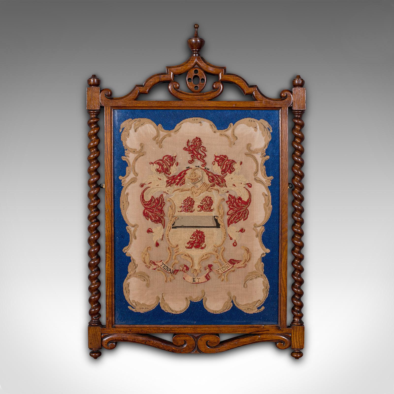 This is an antique framed coat of arms. An English, needlepoint heraldic tapestry in oak frame, dating to the Victorian period, circa 1900.

Presented beautifully within a quality frame
Displays a desirable aged patina and in good