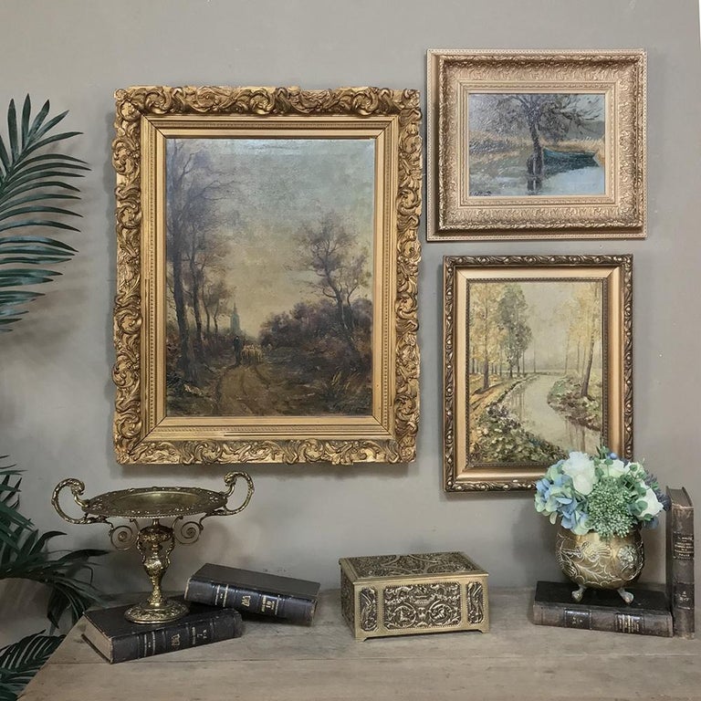 Antique framed landscape oil painting on canvas is a Classic pastoral but oriented on the vertical allowing the stream to gently Meander through the composition surrounded by tranquil forest. The gold and green tones are made to blend splendidly